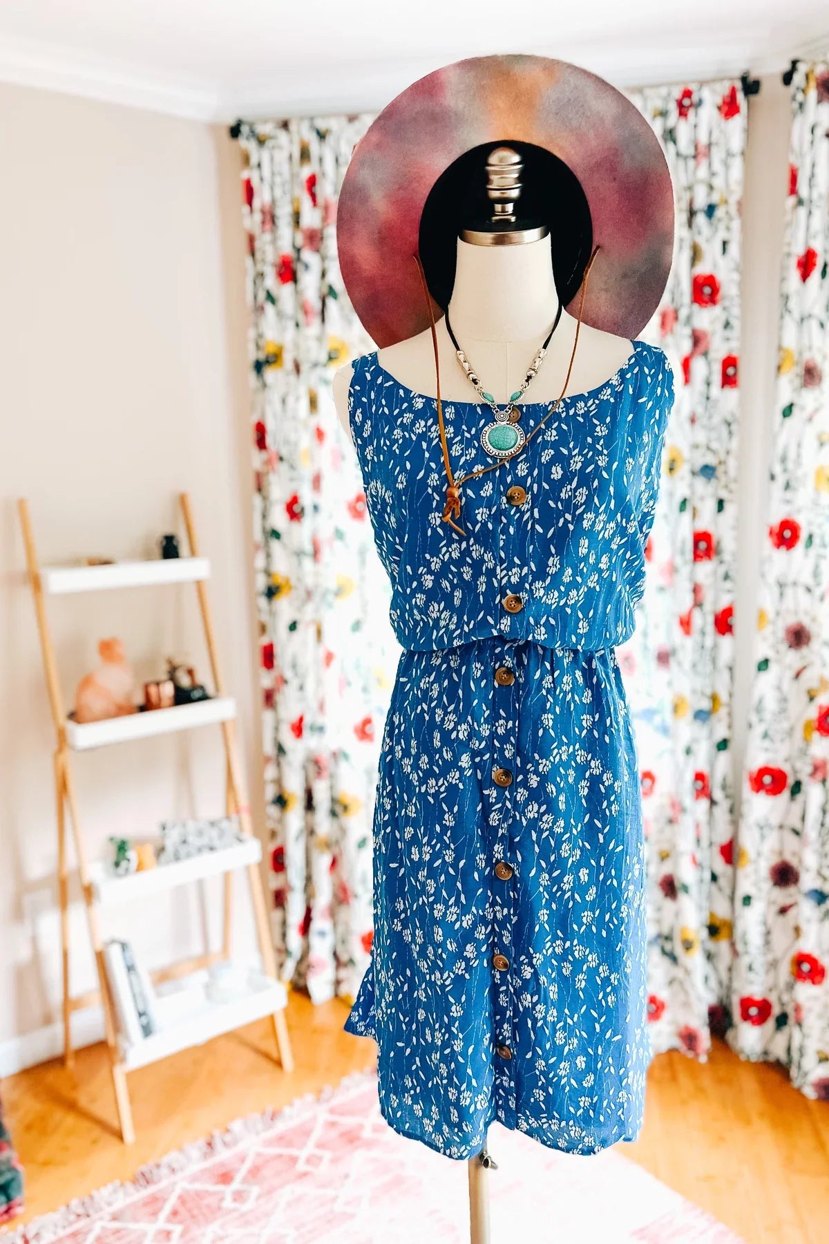 Dress form wearing a blue summer floral dress.