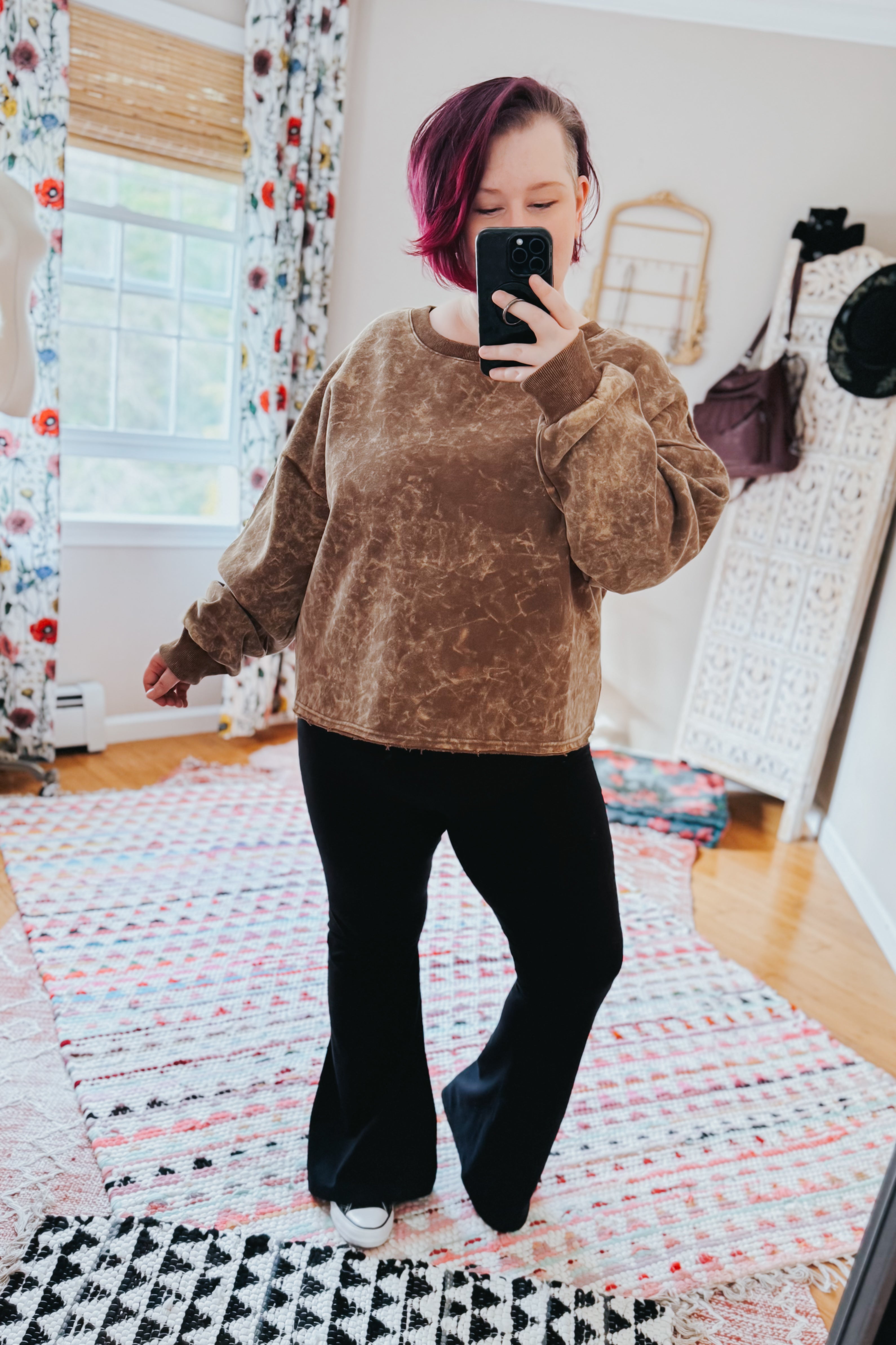 Person taking mirror selfie wearing mocha acid wash pullover with relaxed fit and black flared pants indoors, gallery 0