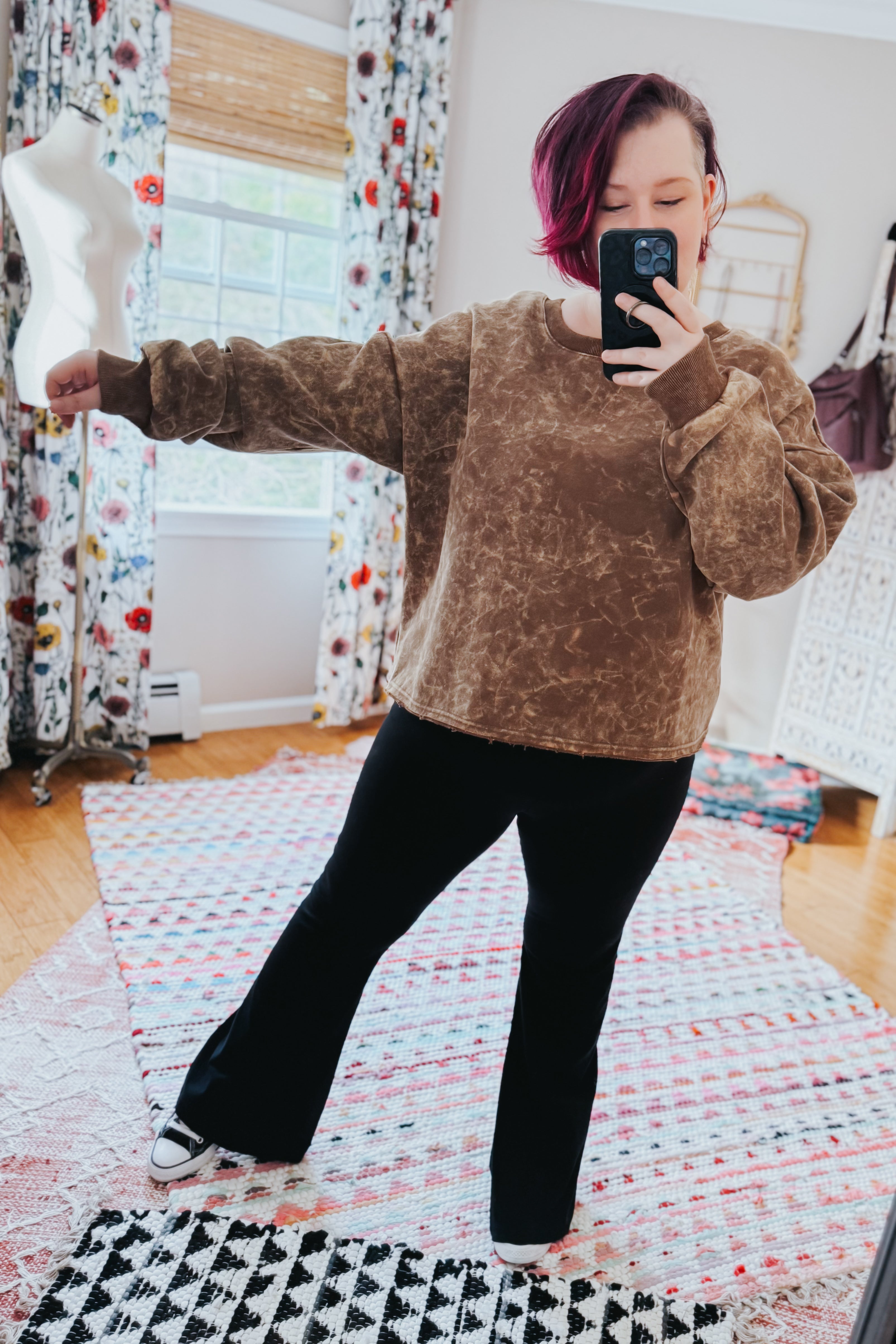 Person taking mirror selfie wearing mocha acid wash cropped pullover with long sleeves and black flare pants indoors, gallery 0