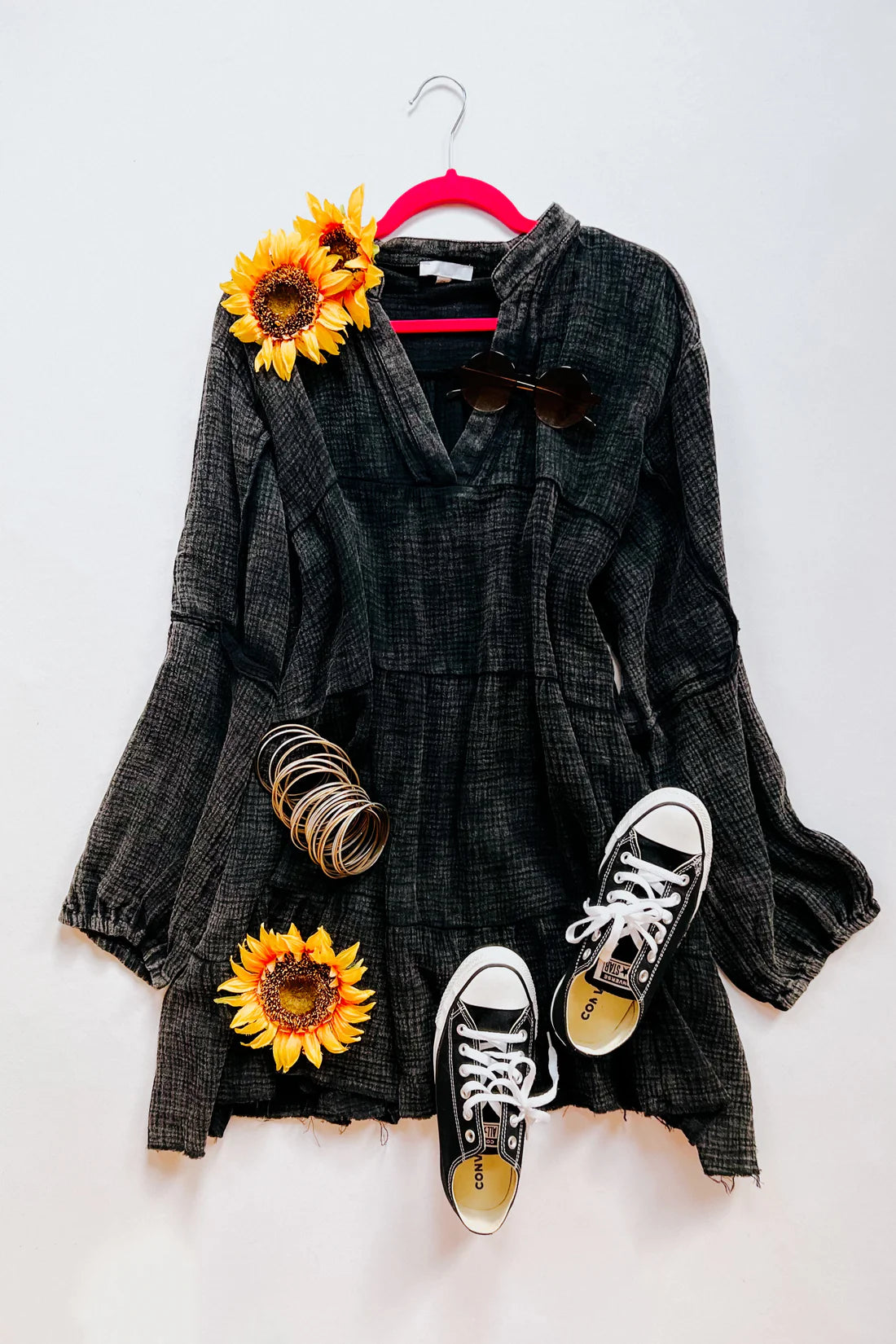 Dark mineral wash V-neck dress with long sleeves paired with black Converse sneakers and sunglasses flat lay