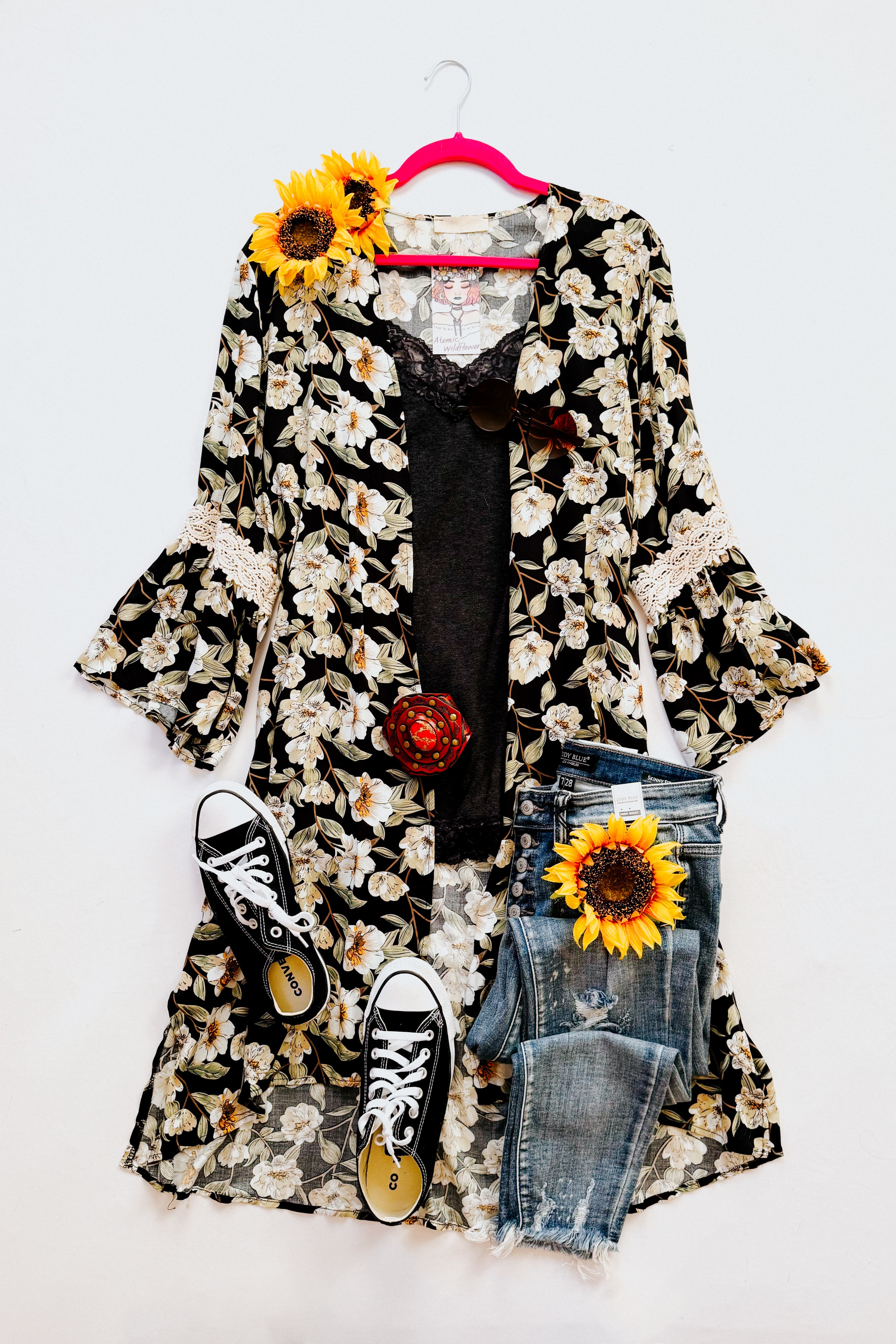 Black floral 3/4 bell sleeve duster with cream lace trim layered over black lace tank with jeans and black sneakers on white background