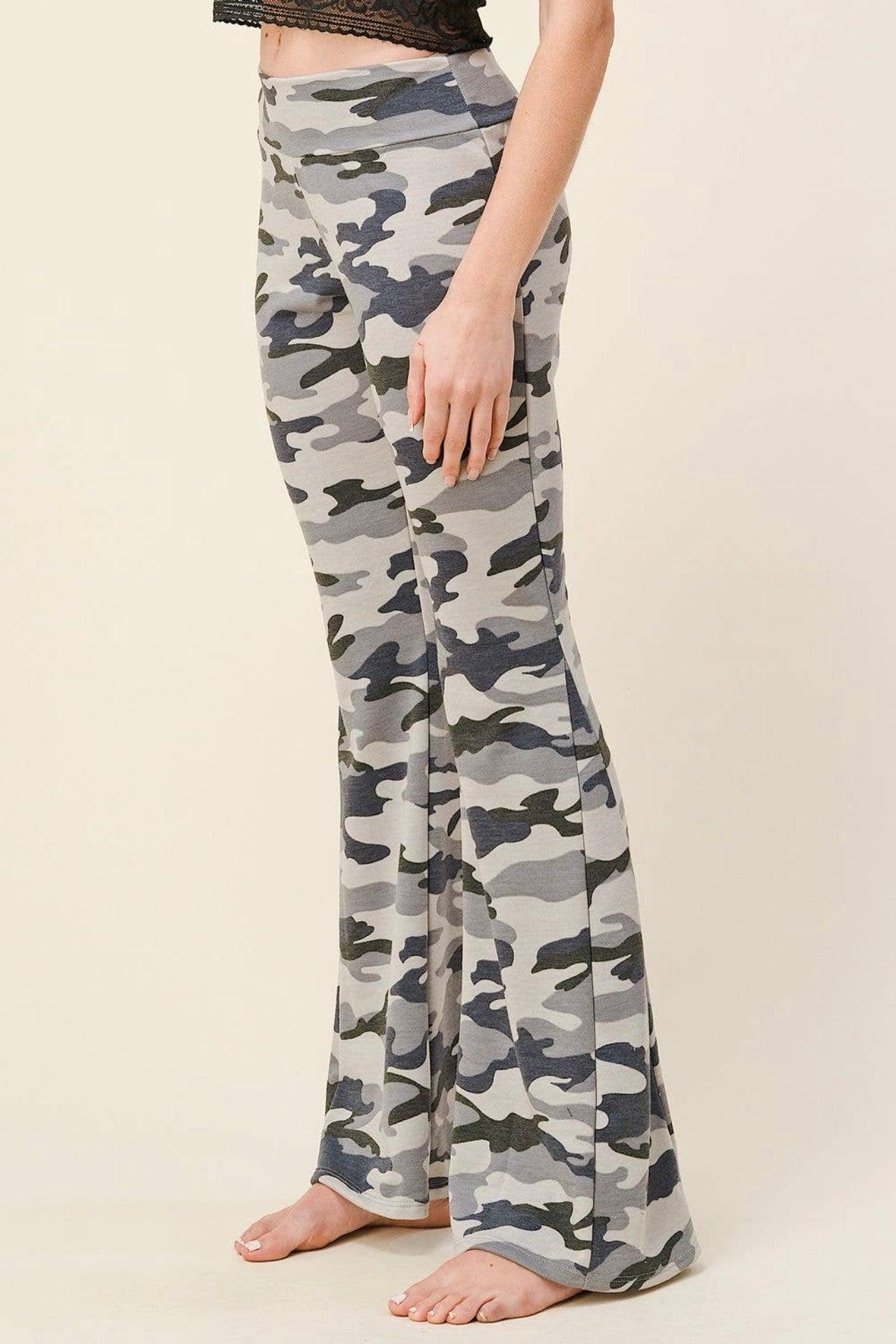 Side view of flared pants in light grey and navy blue camouflage print worn barefoot by a standing model