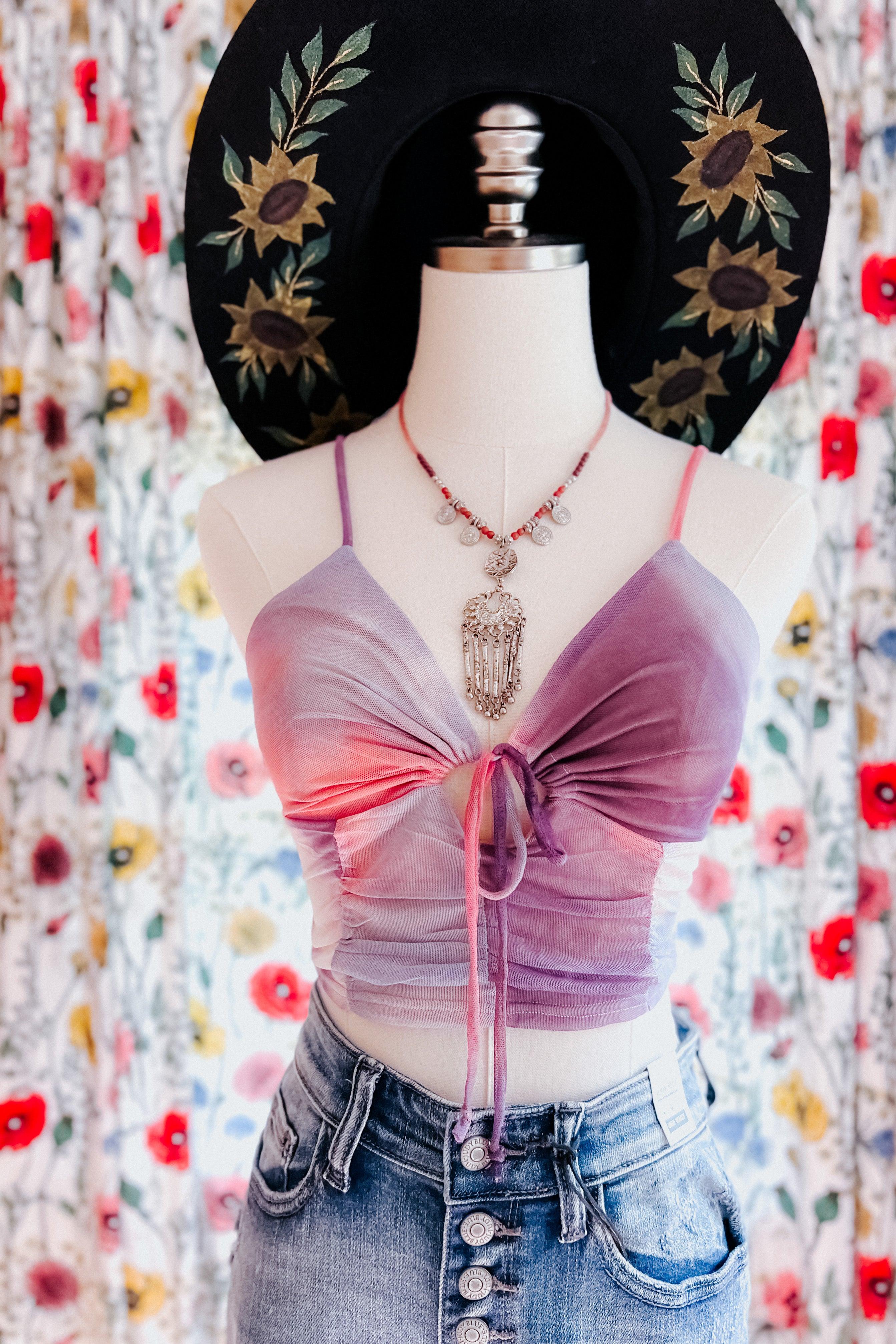 Pink and purple tie dye ruched brami top with front drawstring on mannequin wearing denim jeans and layered necklace