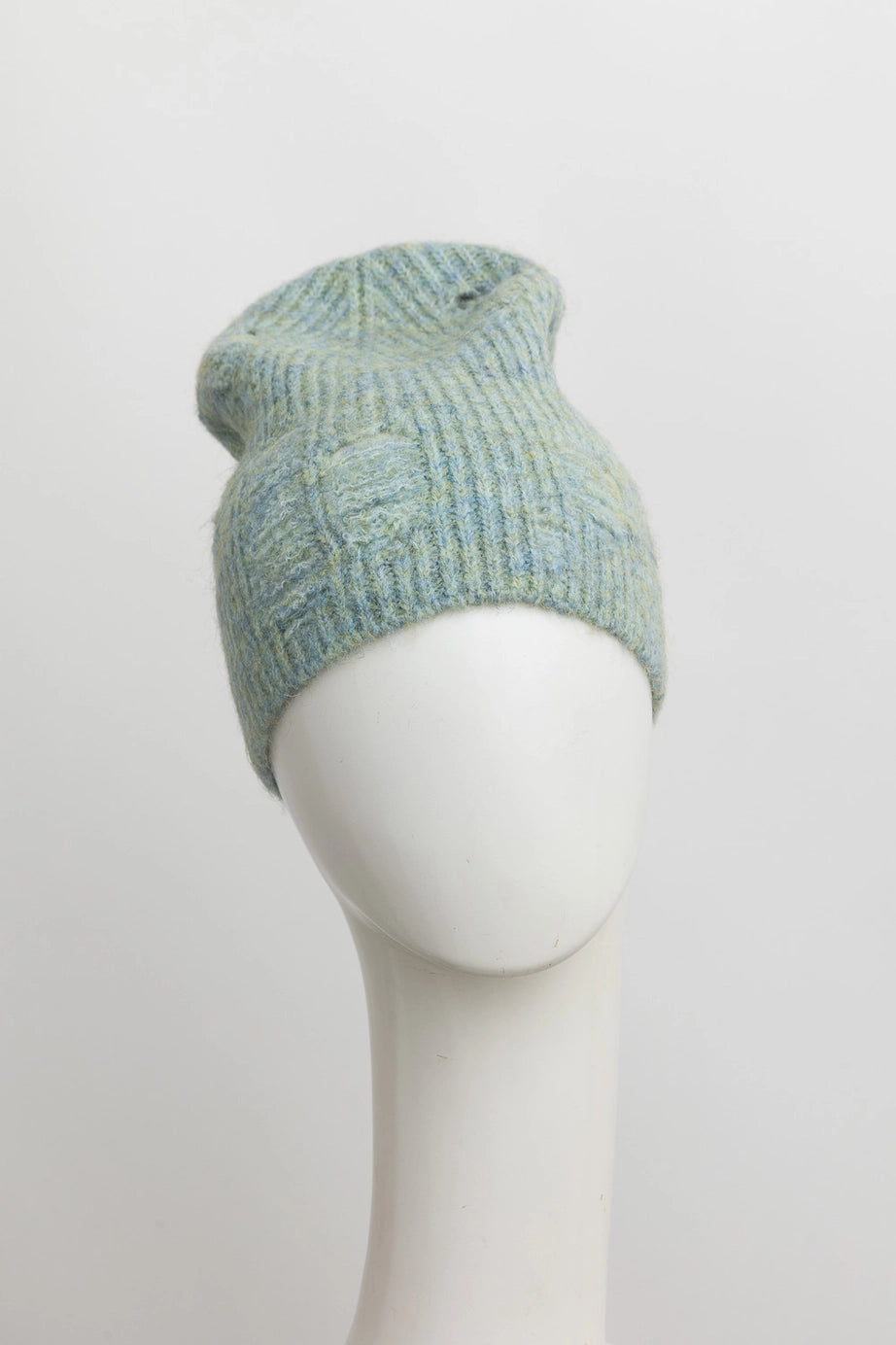 Light mint green ribbed knit beanie with subtle distressed details displayed on white mannequin head