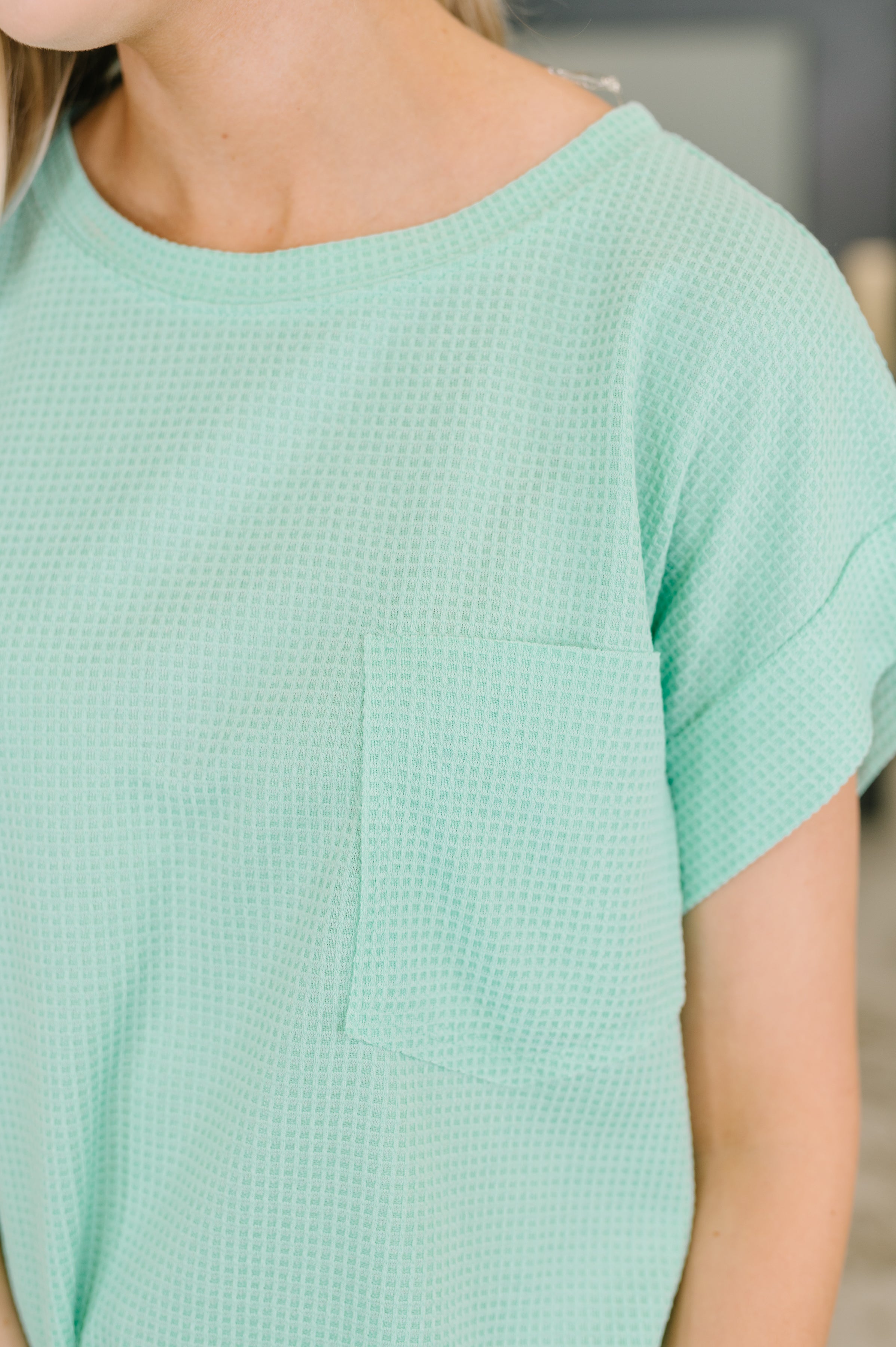 Close-up of mint waffle knit relaxed tee with short sleeves and chest pocket in eclectic, size-inclusive style