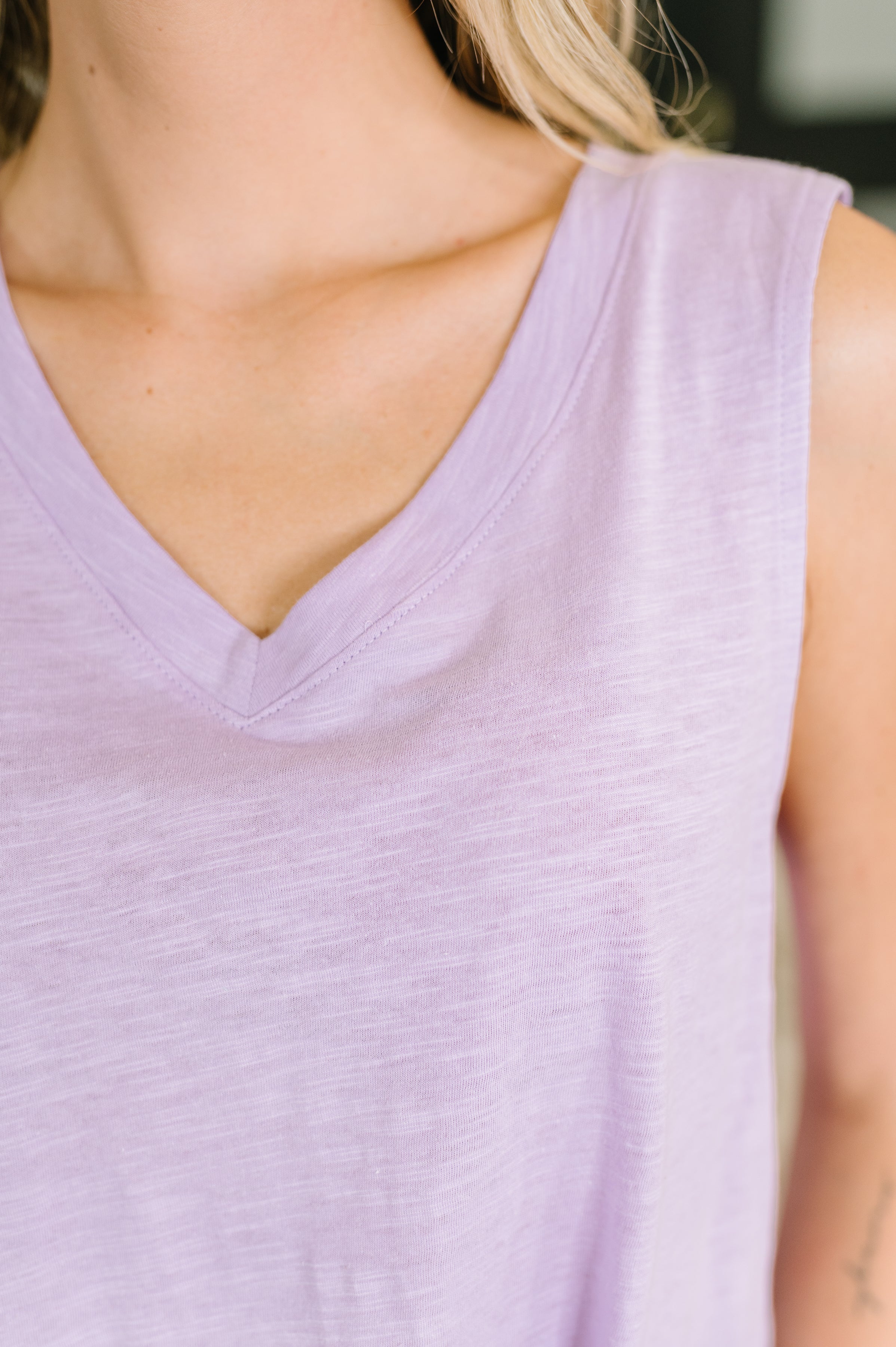 Close-up of soft lilac V-neck tank top with sleeveless cut in a relaxed, free-spirited style