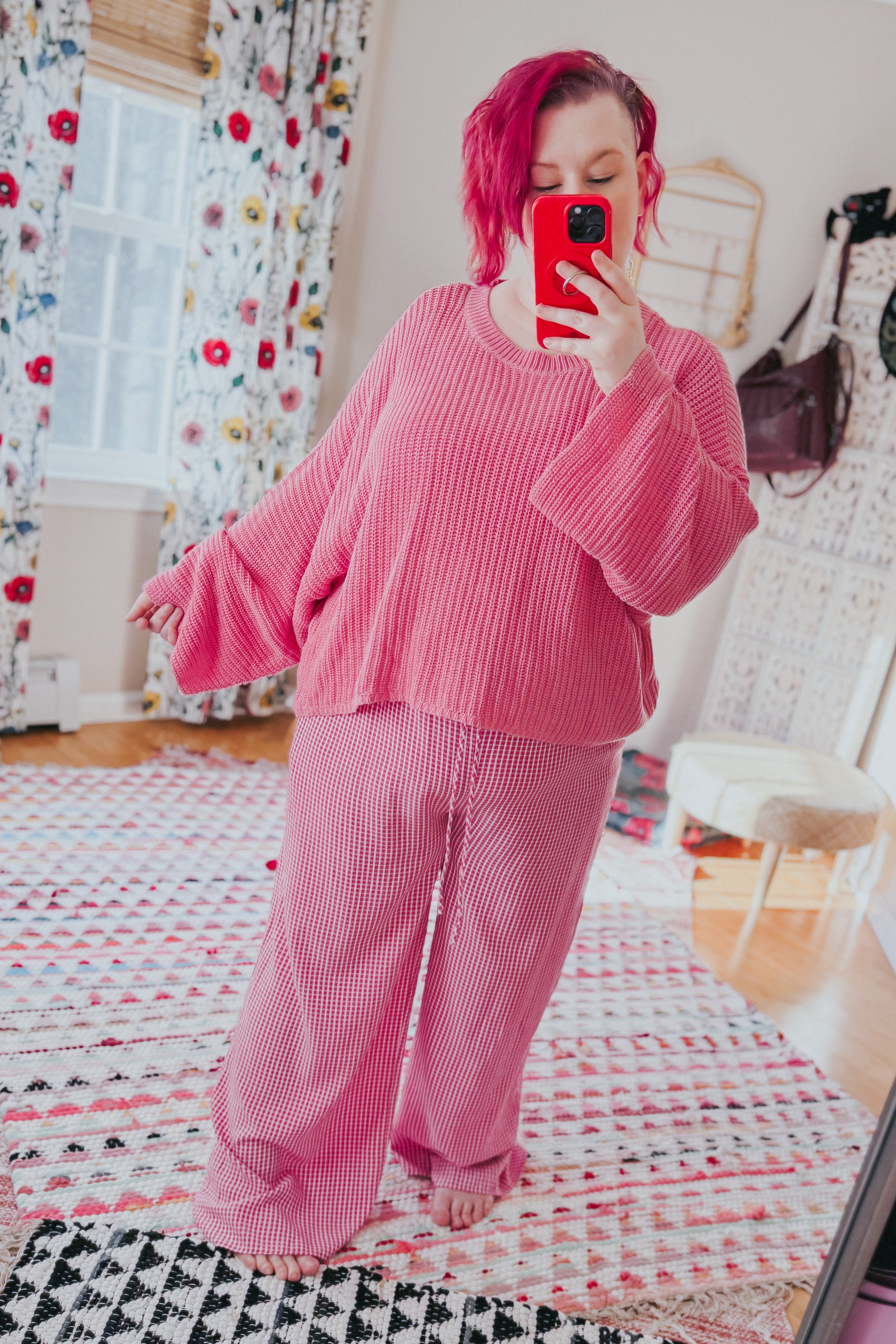 Woman wearing pink In The Groove Checkered Print Pants with relaxed fit standing barefoot in cozy bright room taking mirror selfie