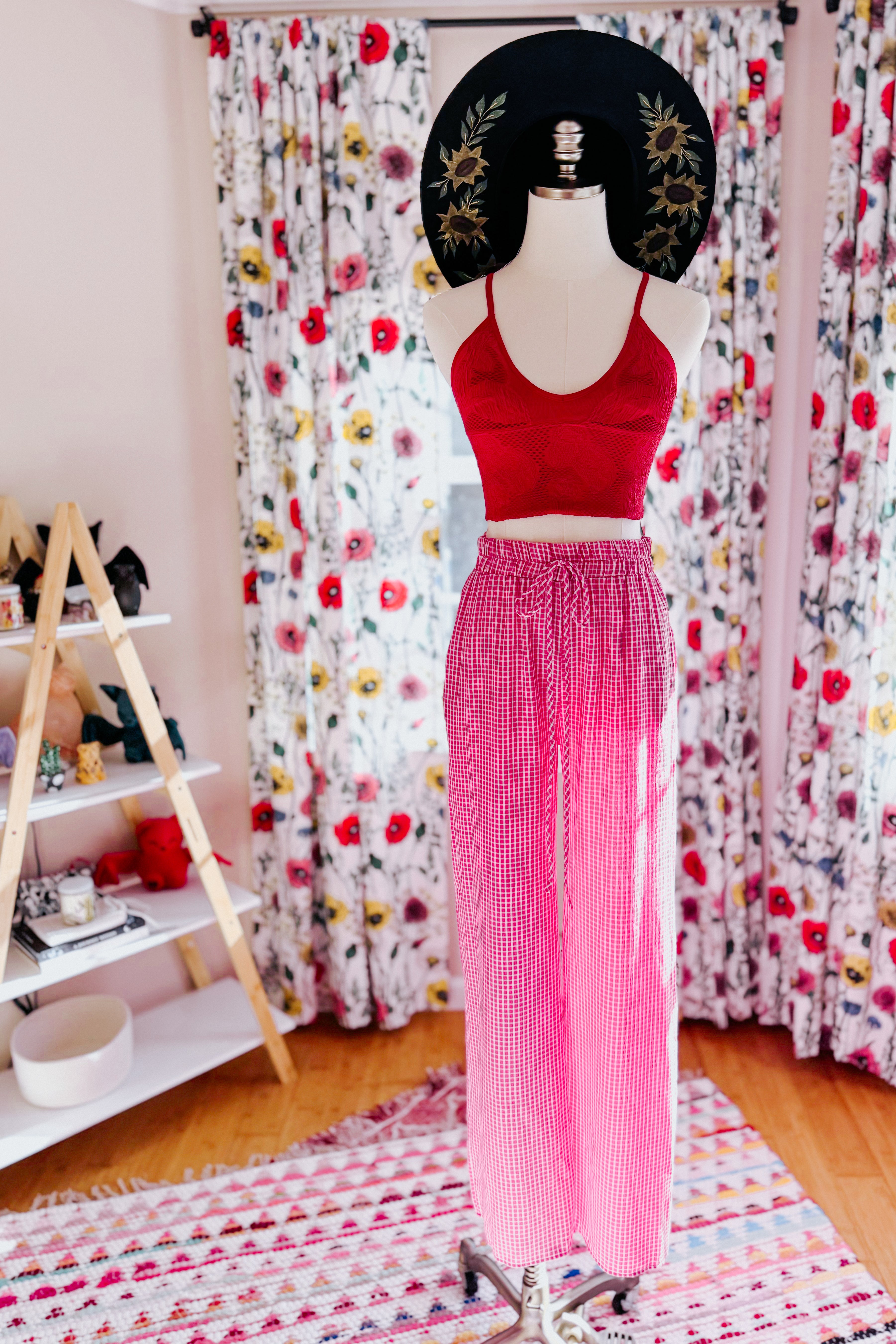 Mannequin dressed in pink In The Groove Checkered Print Pants with drawstring waist and red crop top in bright room