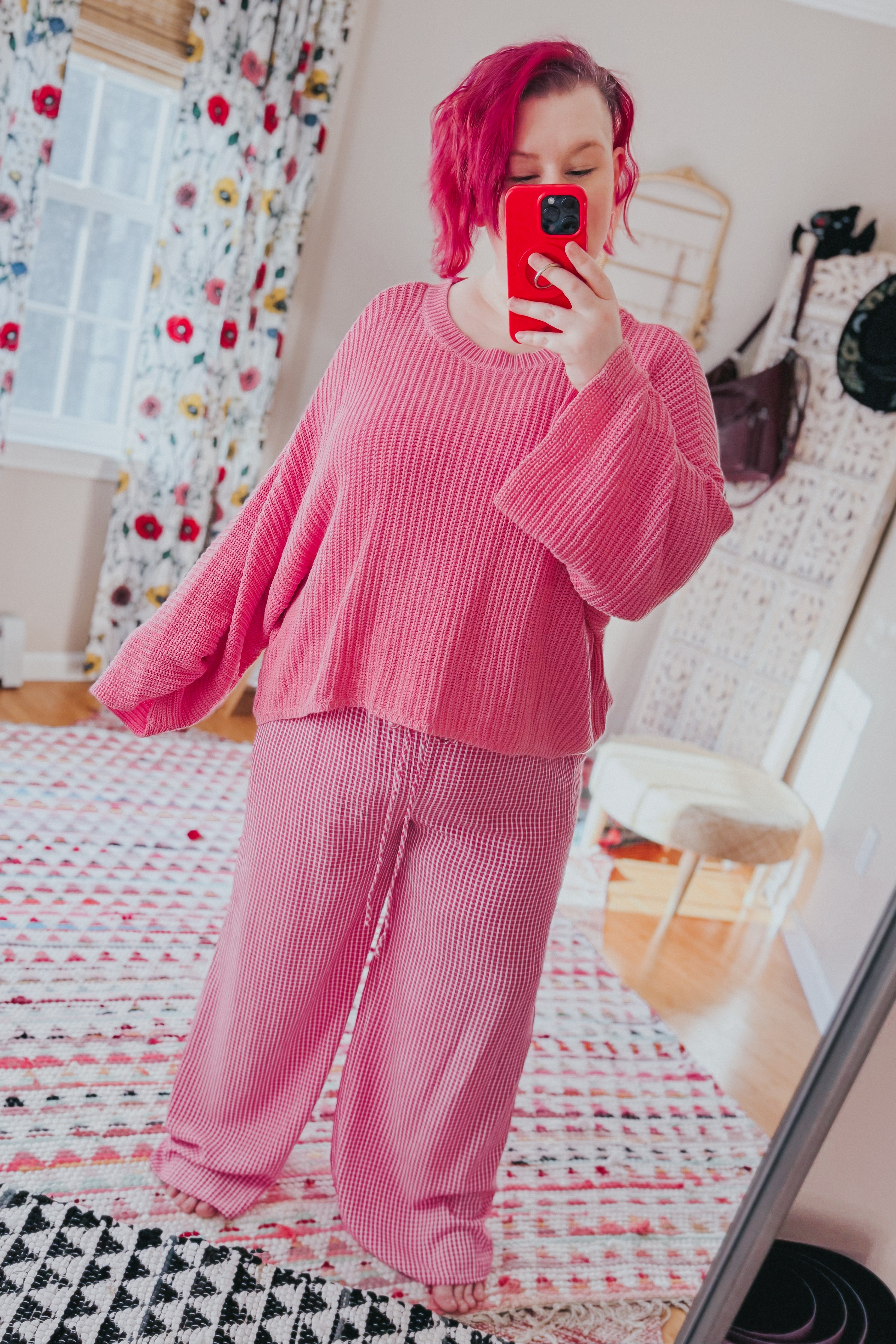 Woman wearing relaxed fit pink In The Groove Checkered Print Pants with drawstring waist taking a mirror selfie indoors