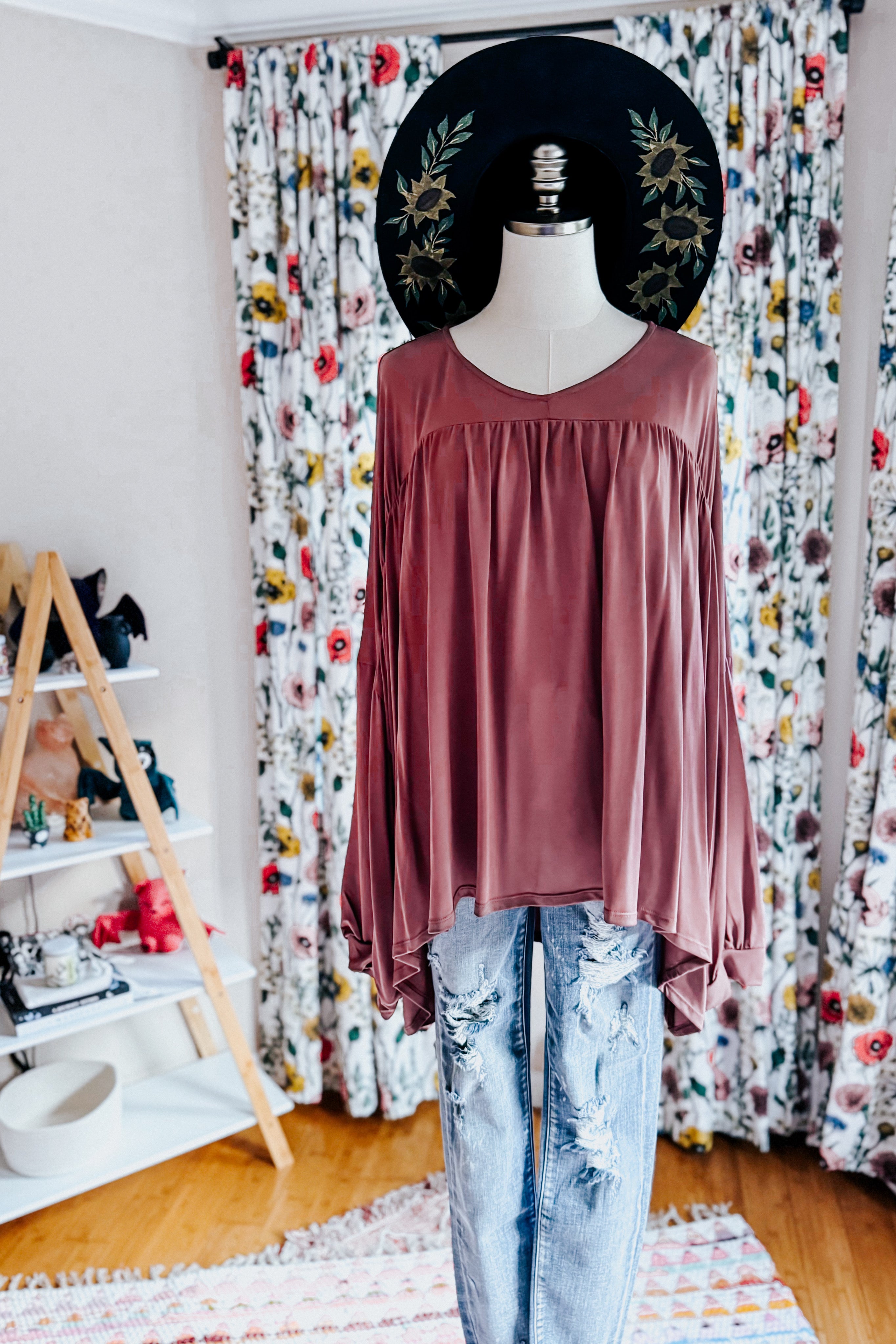 Wine-colored In This Groove modal knit top with a relaxed fit and gathered detail styled on mannequin with distressed jeans