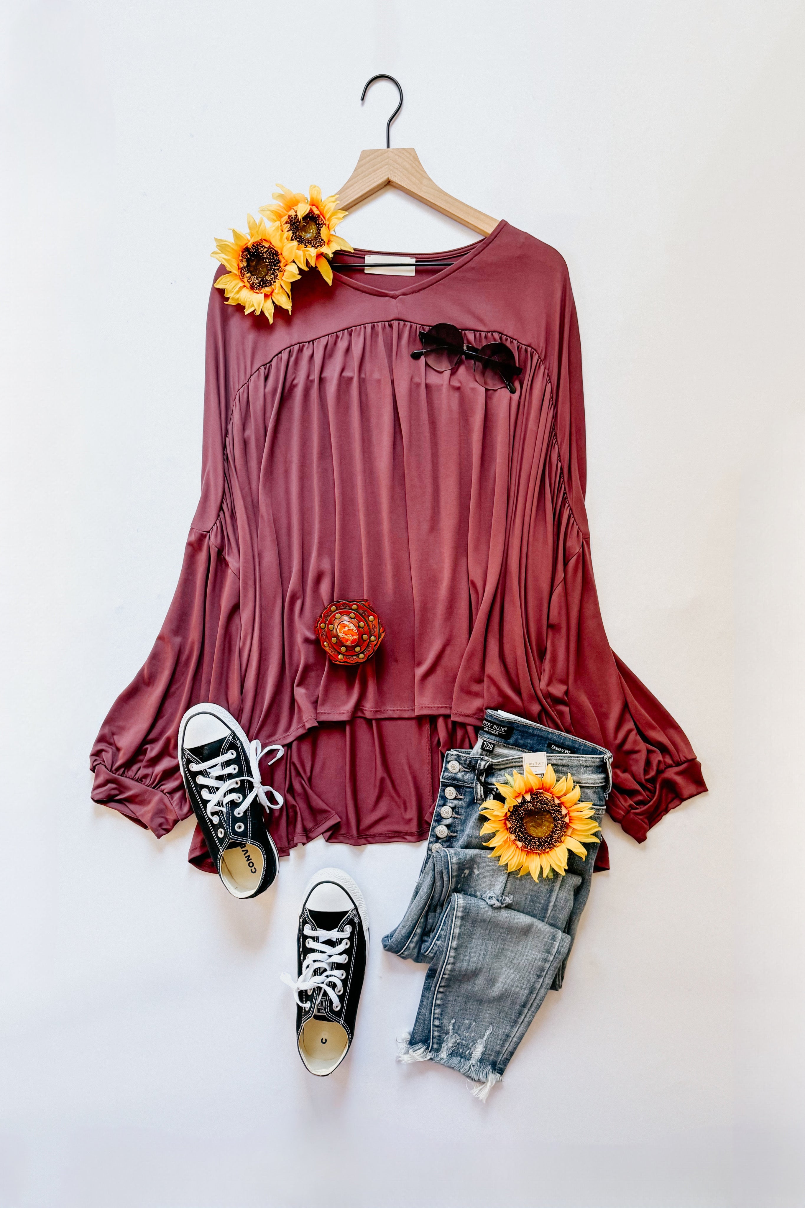 Wine In This Groove modal knit top with gathered detail styled with black canvas sneakers and distressed denim shorts