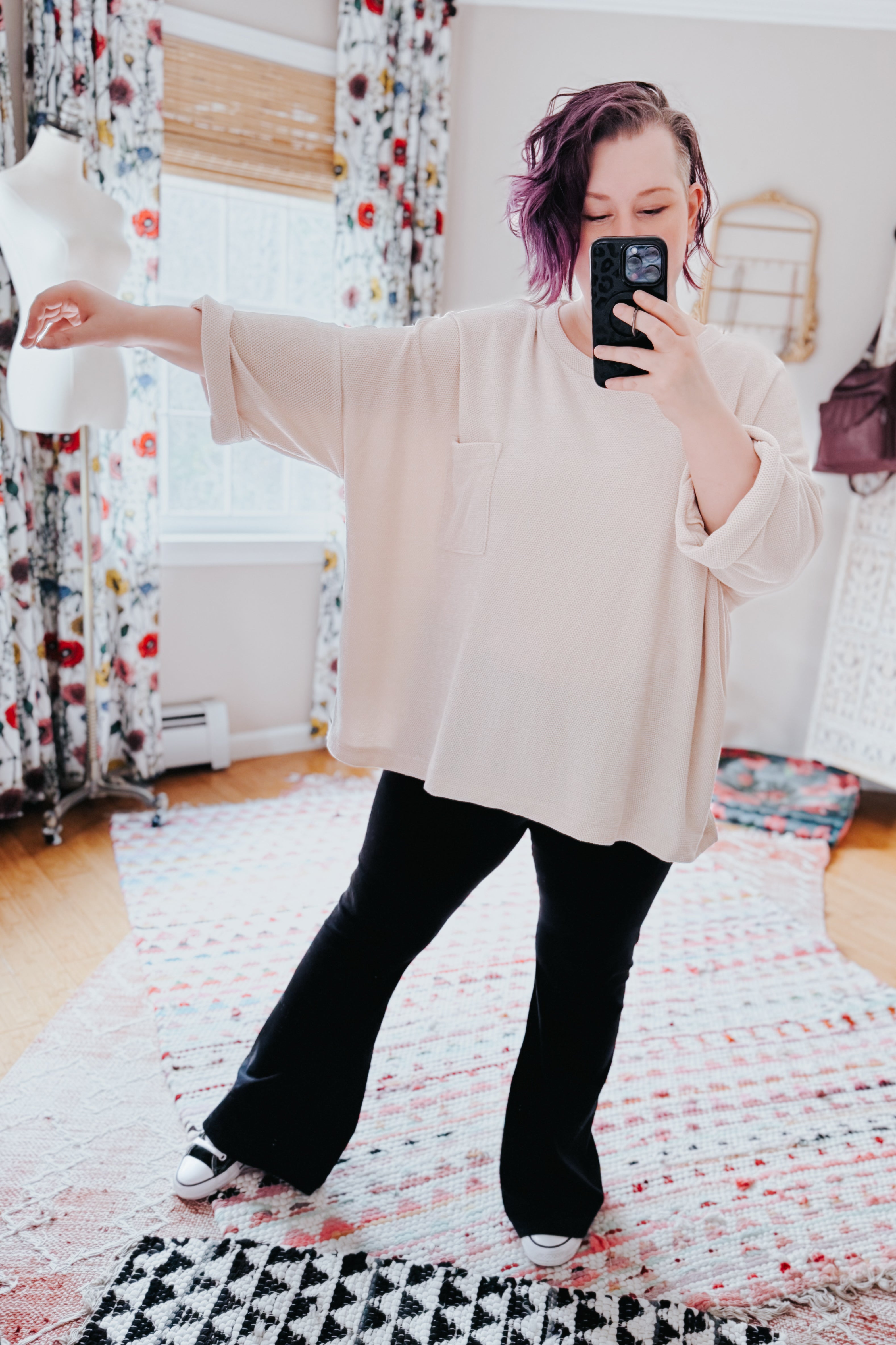 Woman taking selfie wearing loose ivory Thoughts chenille blouse with chest pocket and rolled sleeves indoors