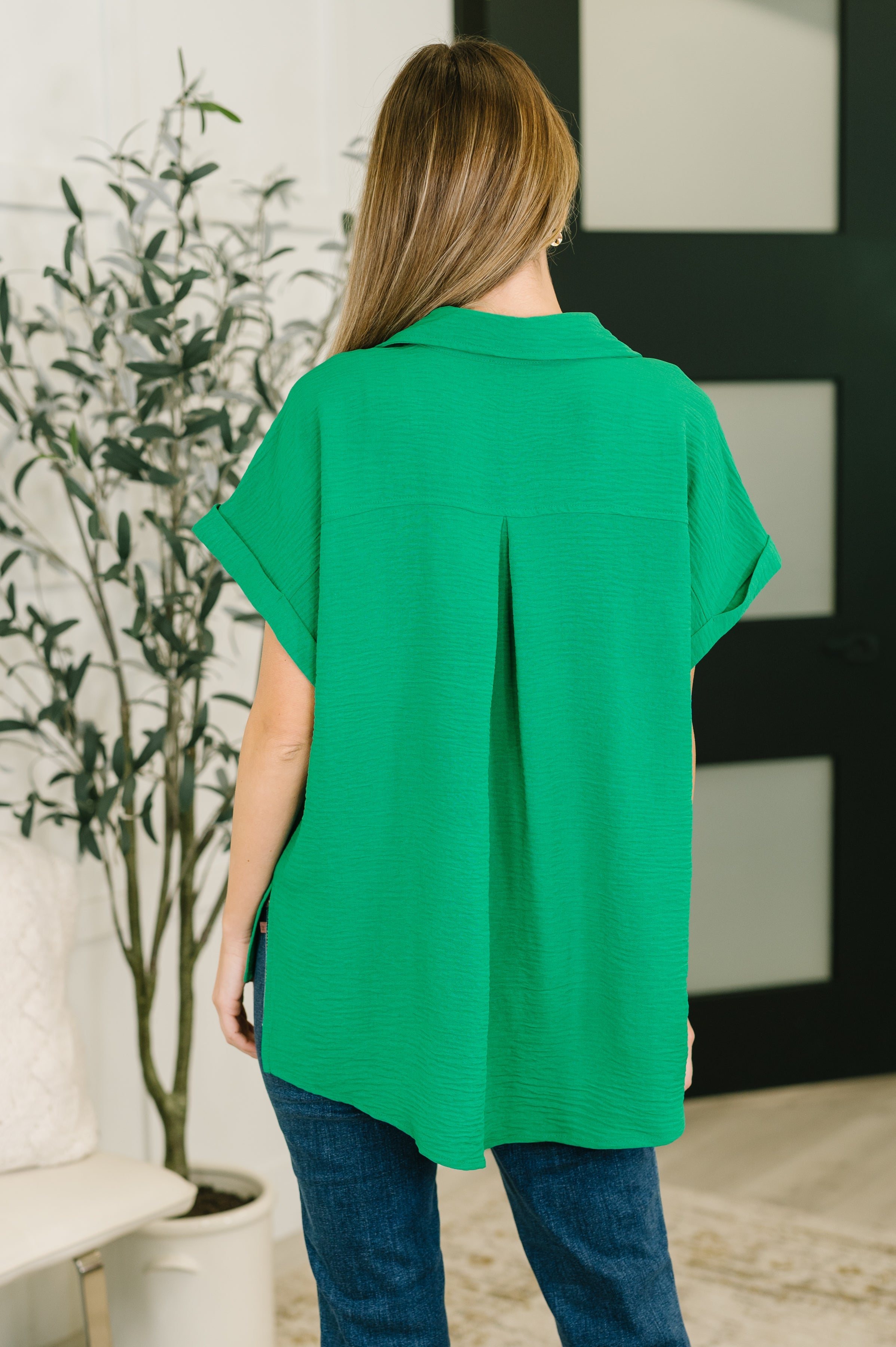 Back view of vibrant green crinkle woven collared top with rolled sleeves in an eclectic, size-inclusive style