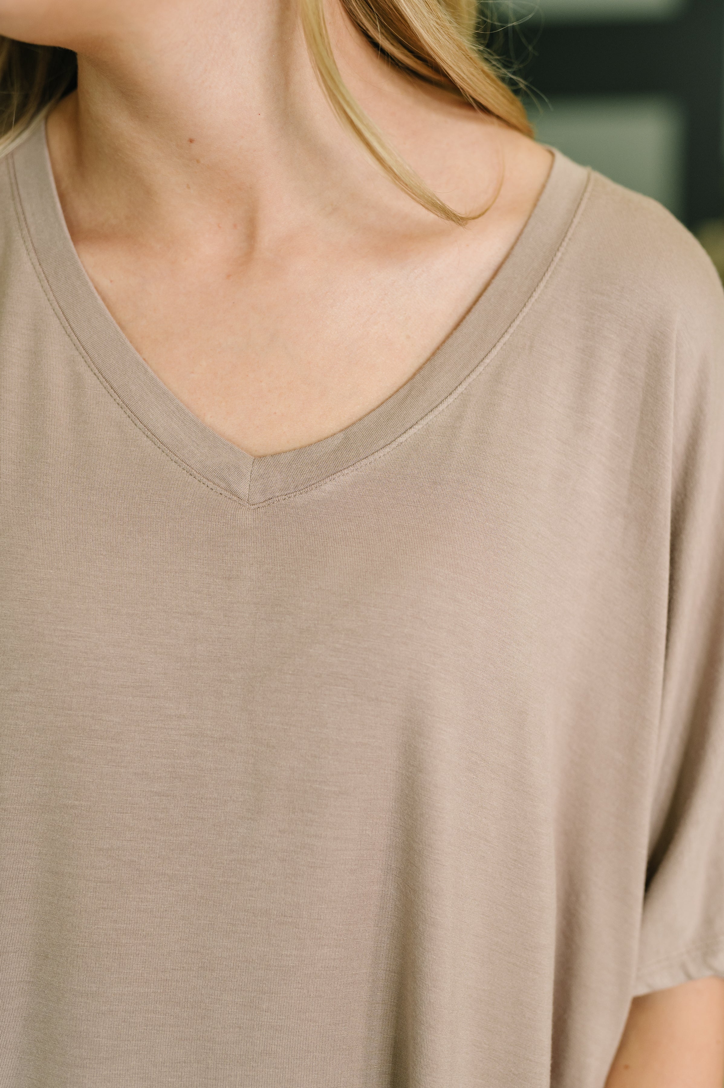 Close-up of a beige V-neck top from a relaxed lounge set, highlighting soft fabric and casual fit