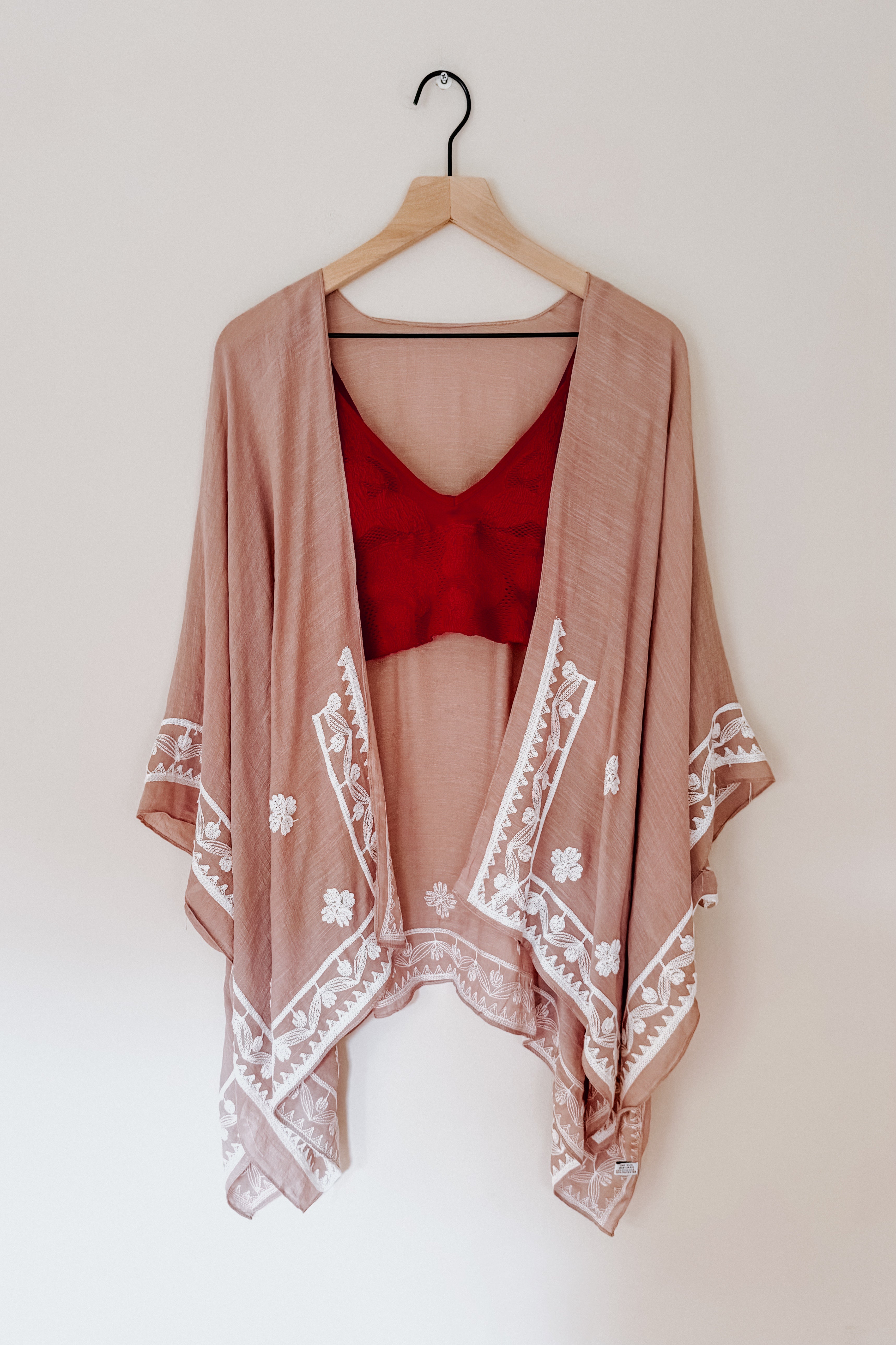 Blush taupe layering piece with white poppy embroidery paired with deep red top in eclectic, free spirited style