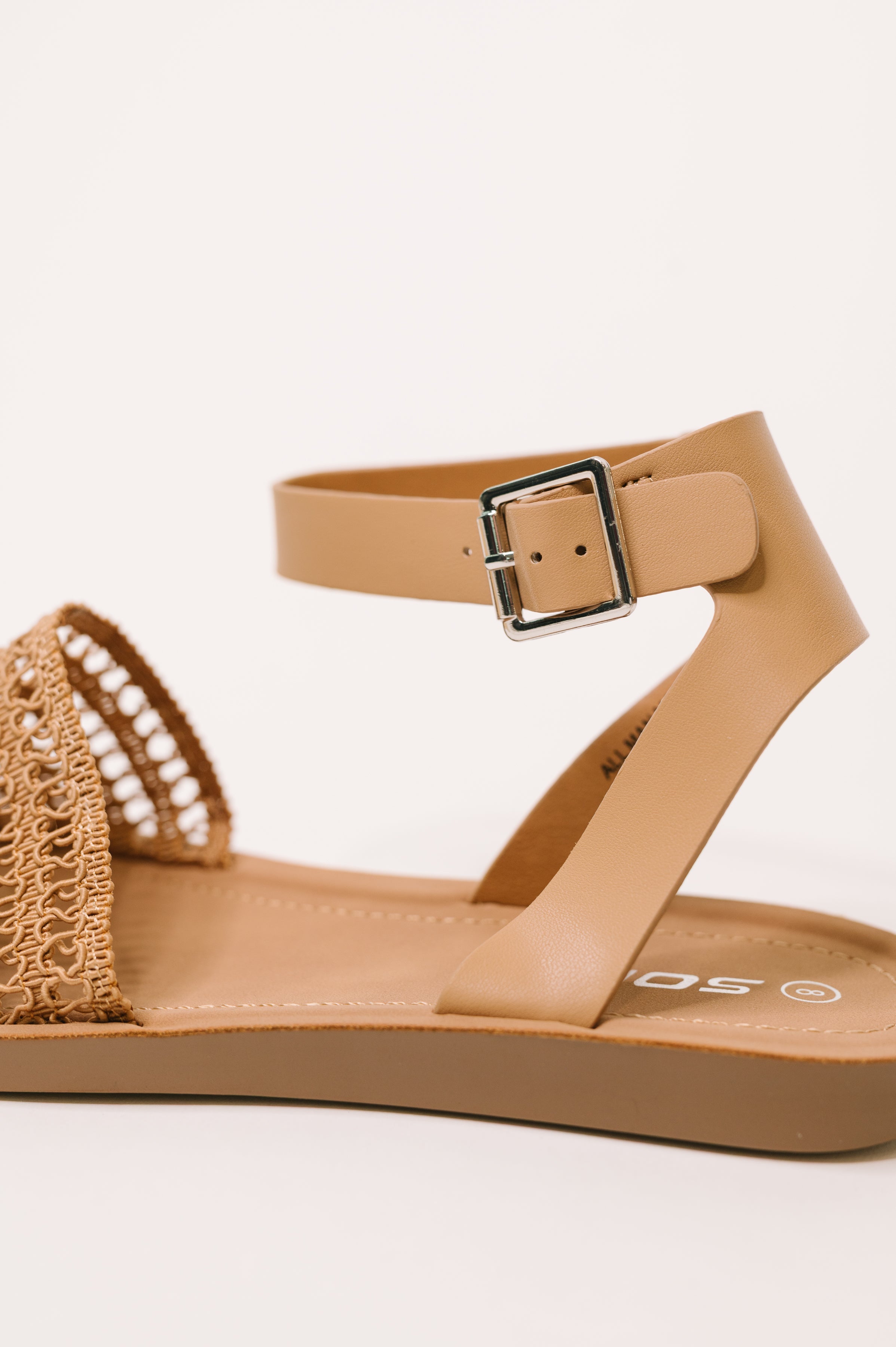 Side view of a camel sandal with woven braided front strap and adjustable ankle buckle against a neutral background