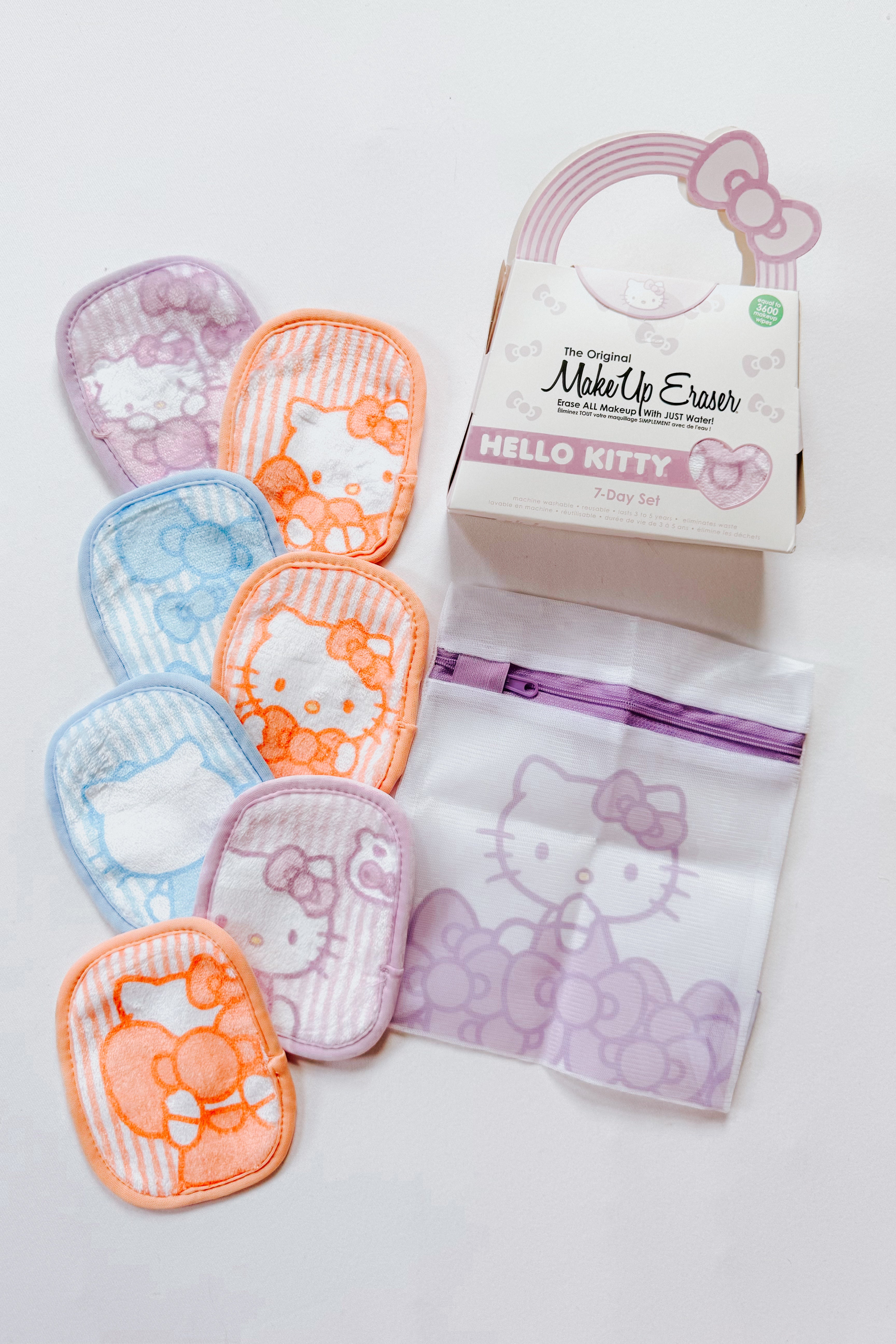 Set of colorful Hello Kitty makeup remover cloths with a reusable mesh bag and decorative packaging on white background