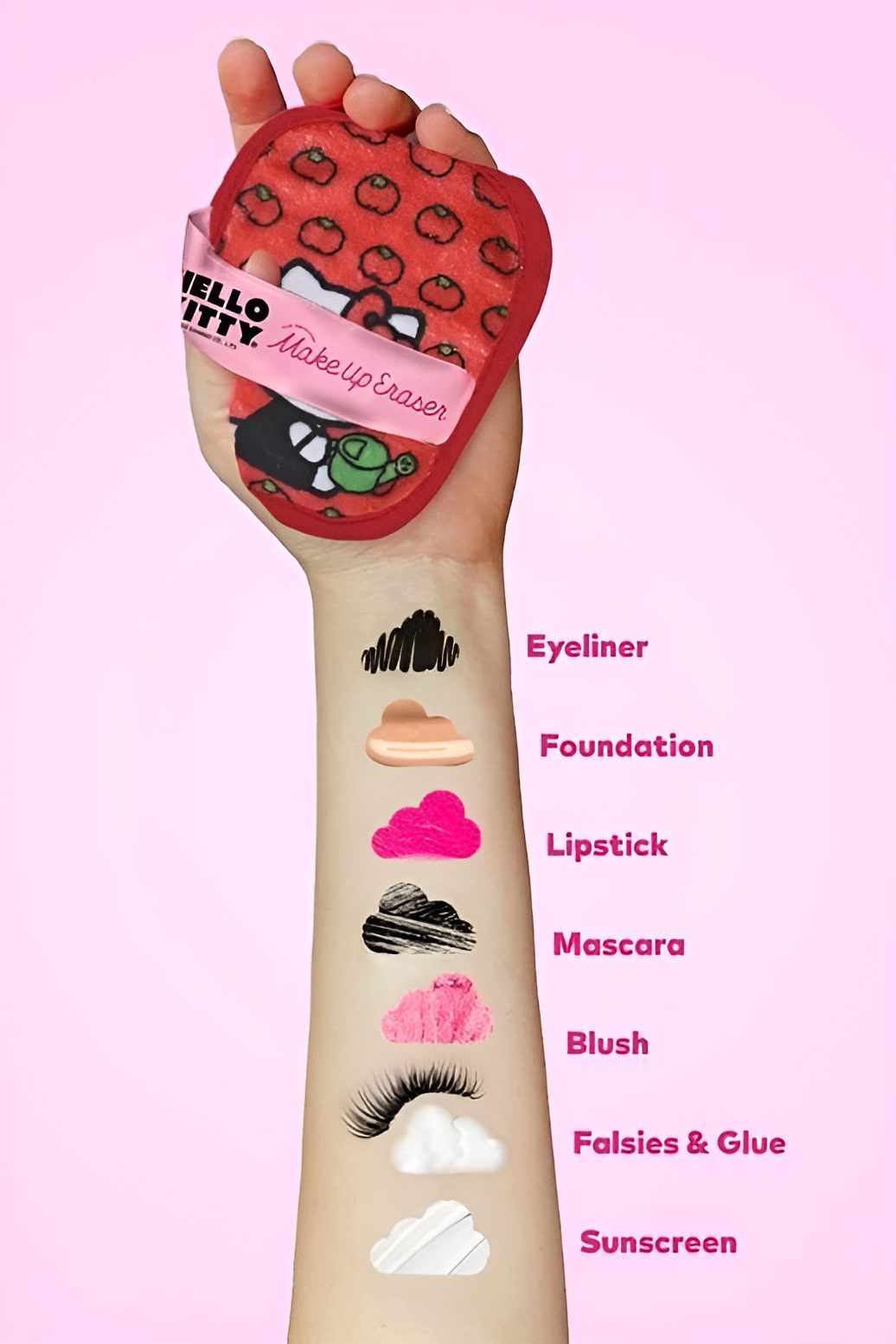 Hand holding red and pink Hello Kitty makeup eraser with swatches of makeup on arm labeled by product type on pink background