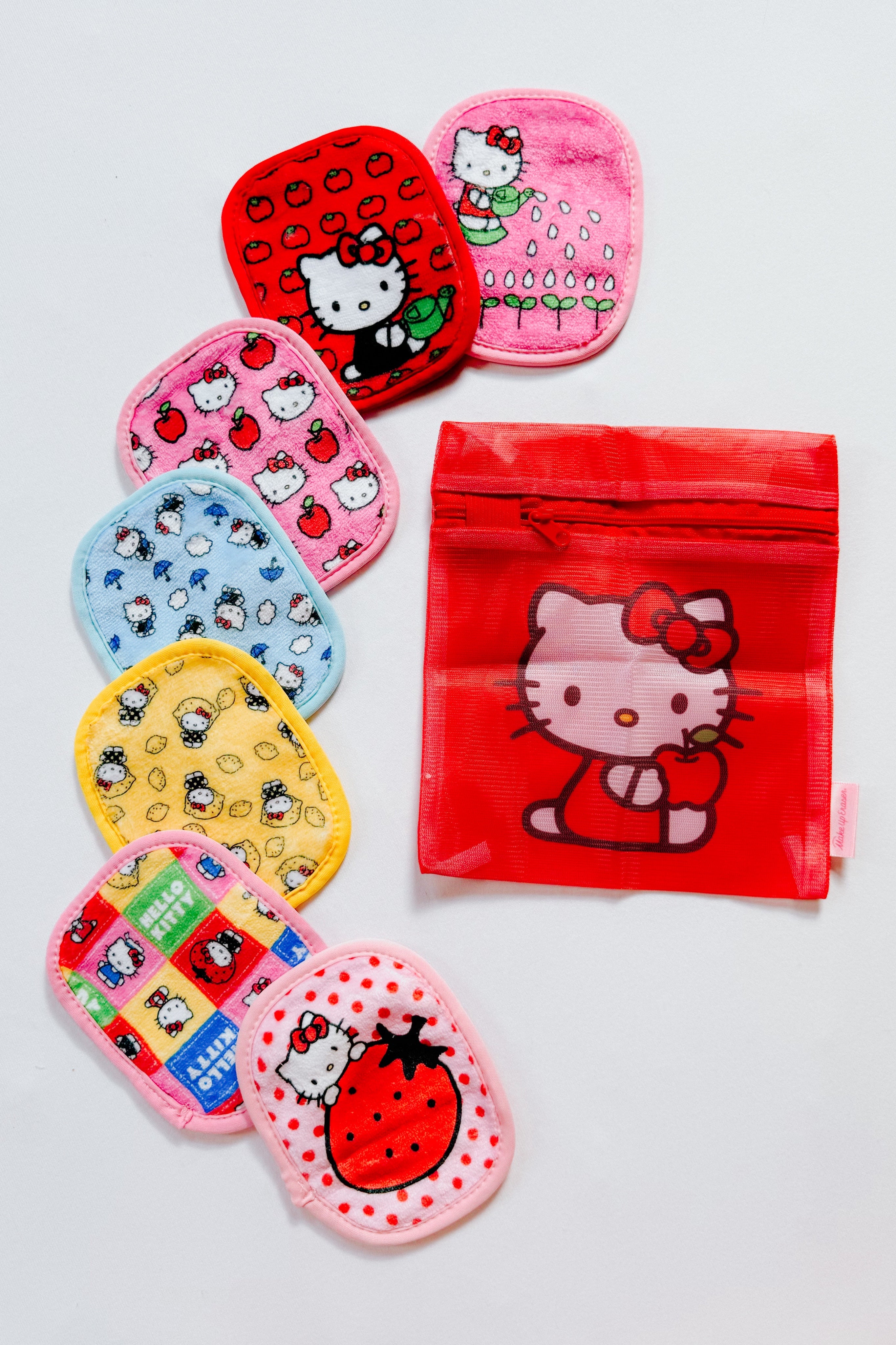 Set of colorful reusable makeup remover pads with Hello Kitty designs and a red zippered pouch featuring Hello Kitty graphic