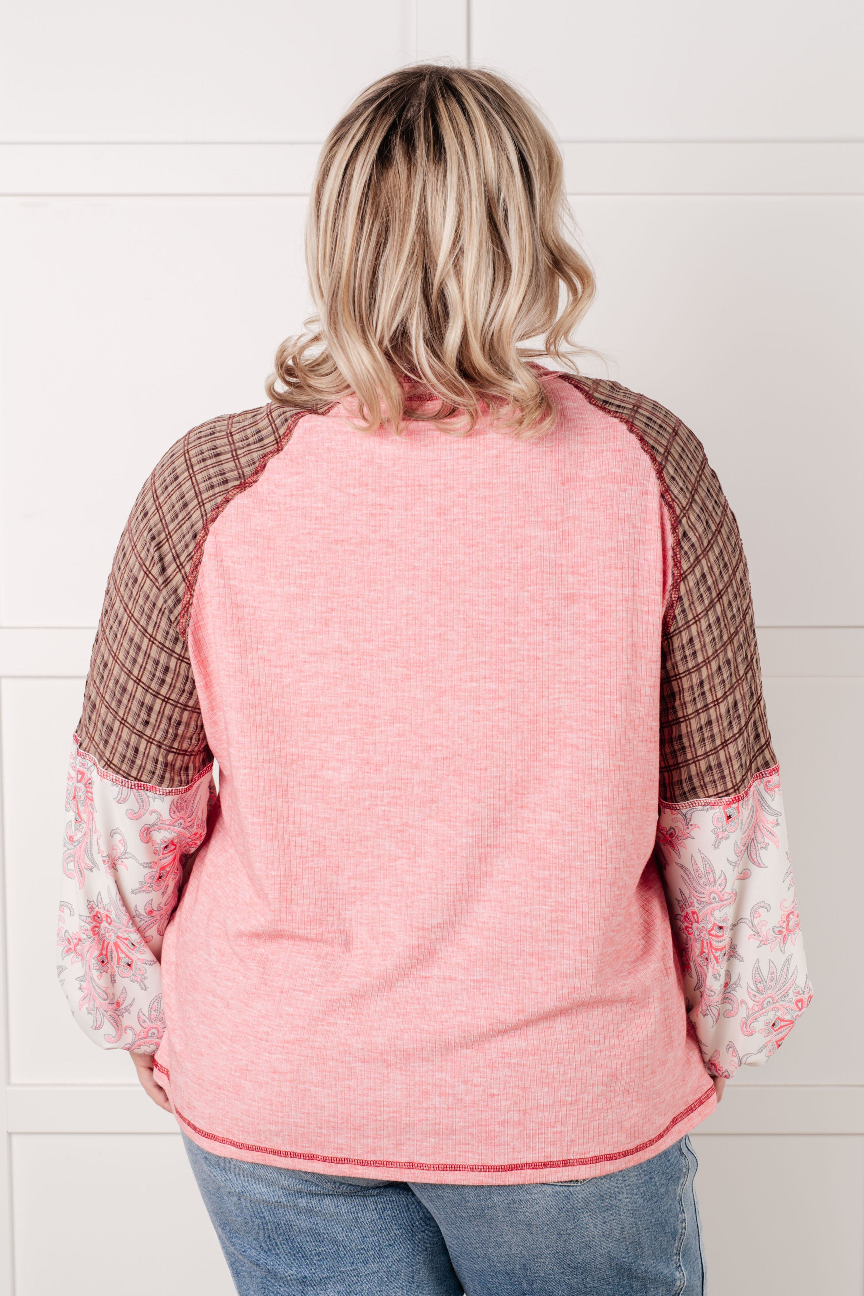 Plus size woman wearing Walk for Miles Floral Color Block Top with pink, brown plaid, and floral sleeves facing away