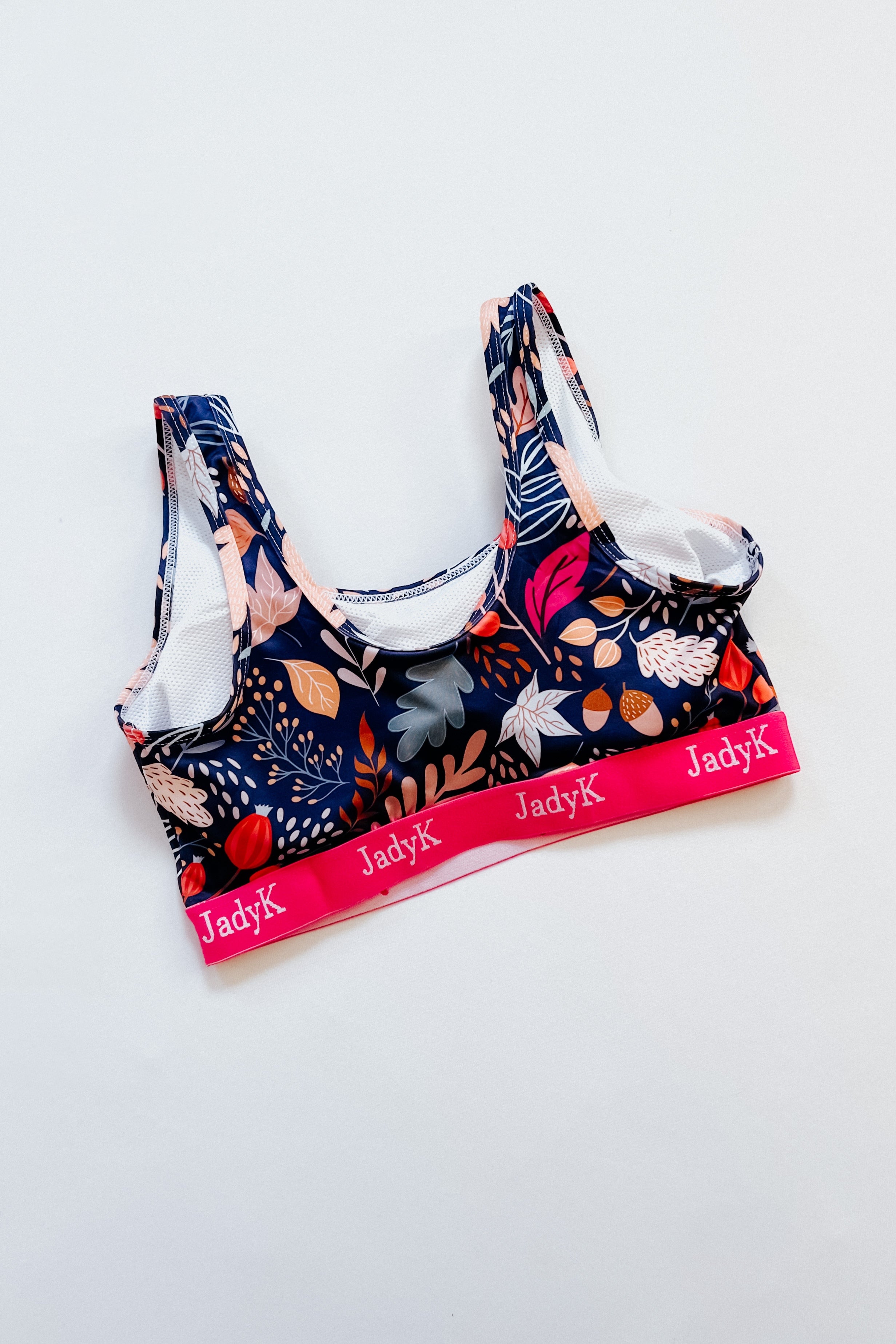 Blue floral scoop bra with pink elastic band featuring JadyK logo on white background