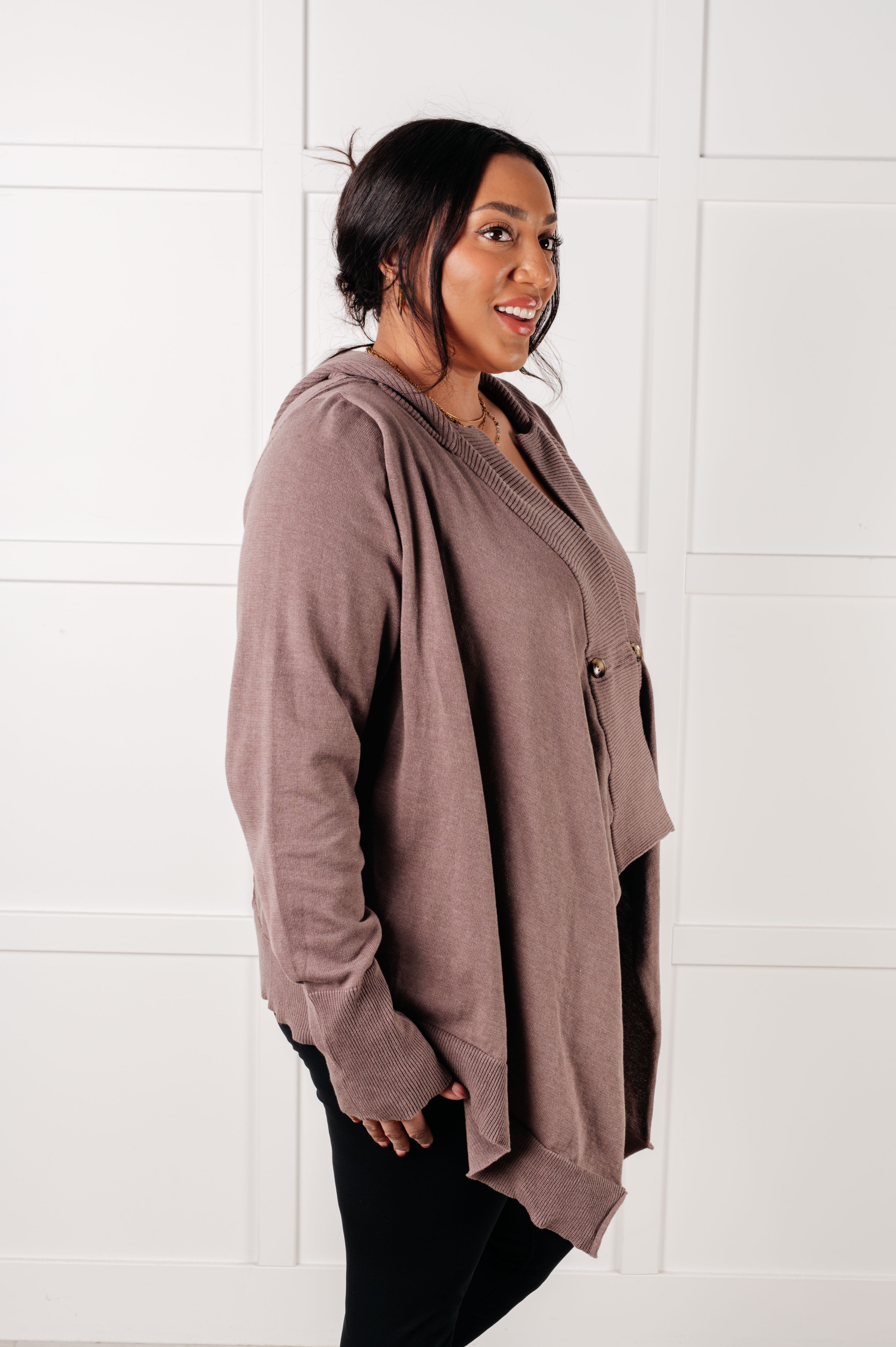 Plus-size woman smiling wearing mocha knit cardigan with textured cuffs and relaxed open front in bright room