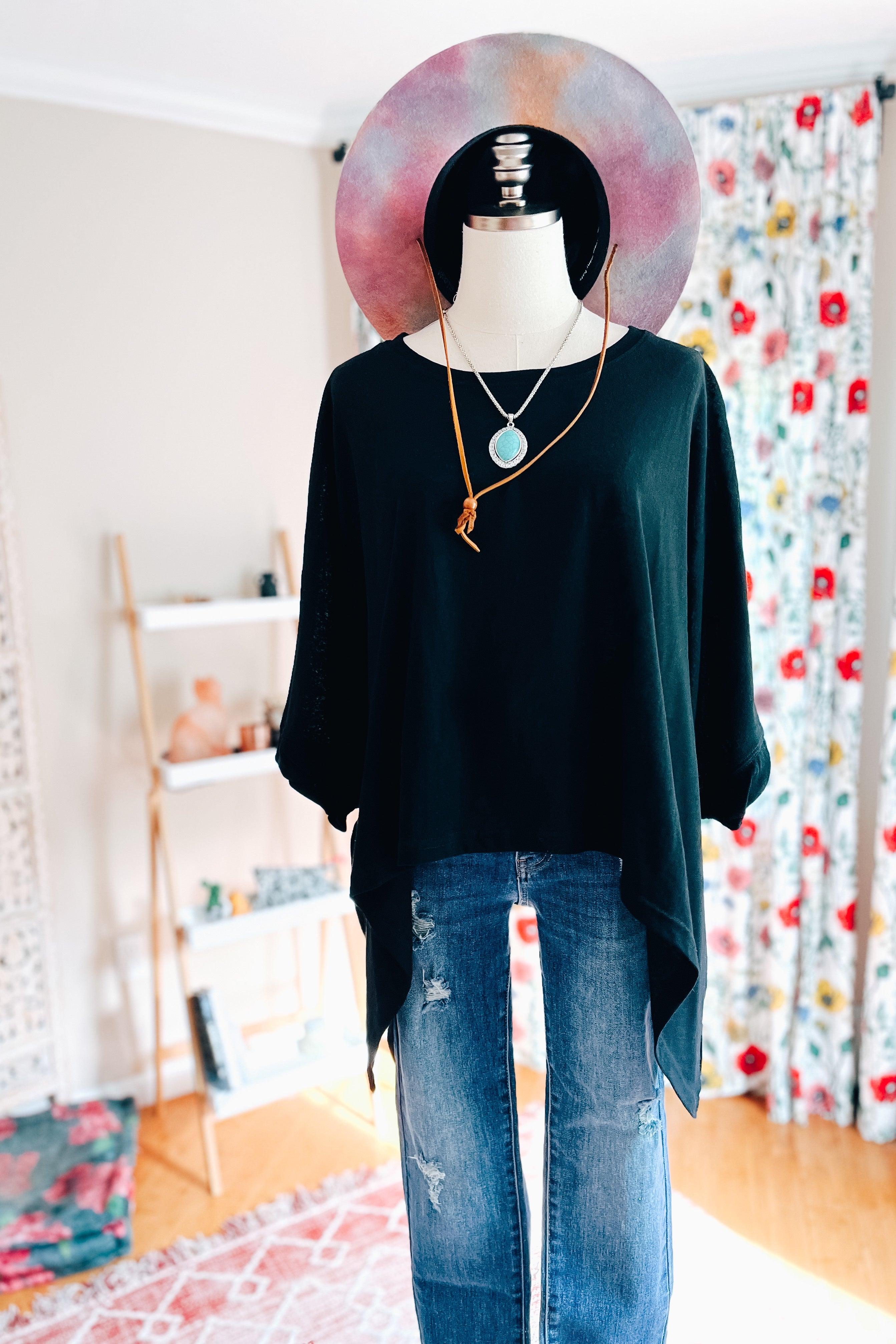 Mannequin dressed in black All My Life Boxy Top with turquoise pendant and tie necklace, paired with distressed blue jeans indoors