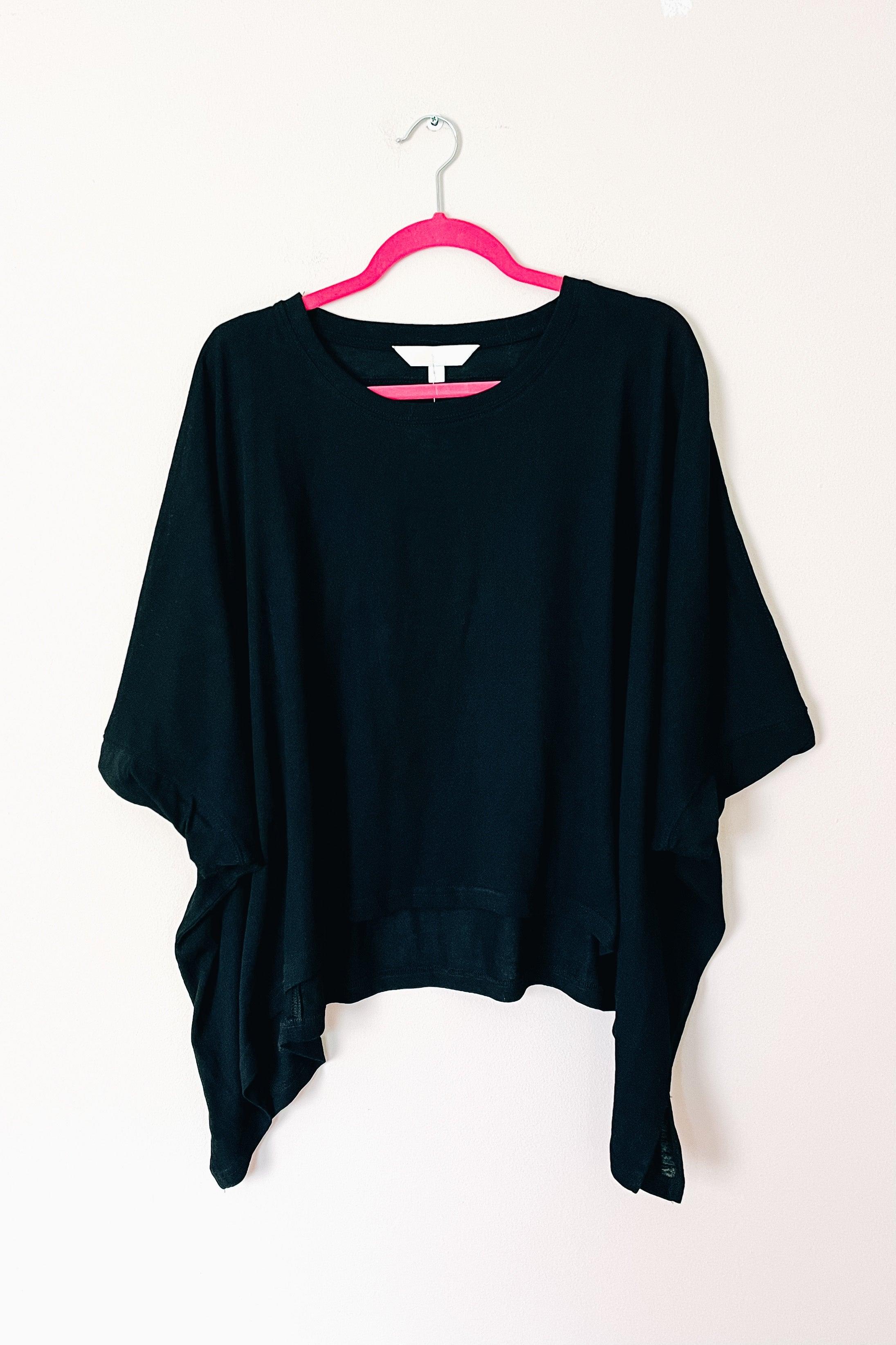 Black All My Life Boxy Top hanging on bright pink hanger against plain white background