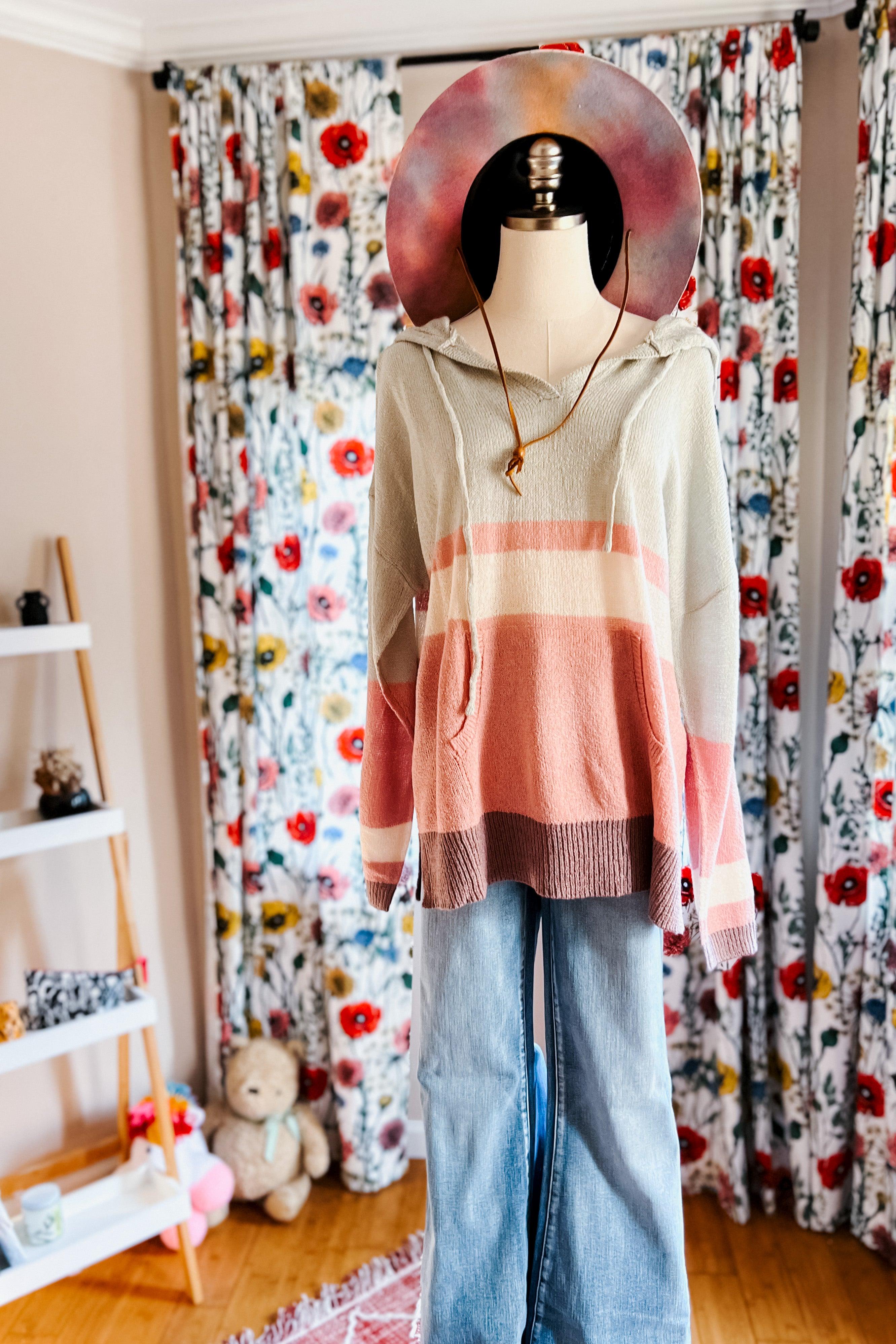 Mannequin dressed in Boy Problem Spring Hoodie with pastel stripes and wide-leg jeans in cozy room with floral curtains