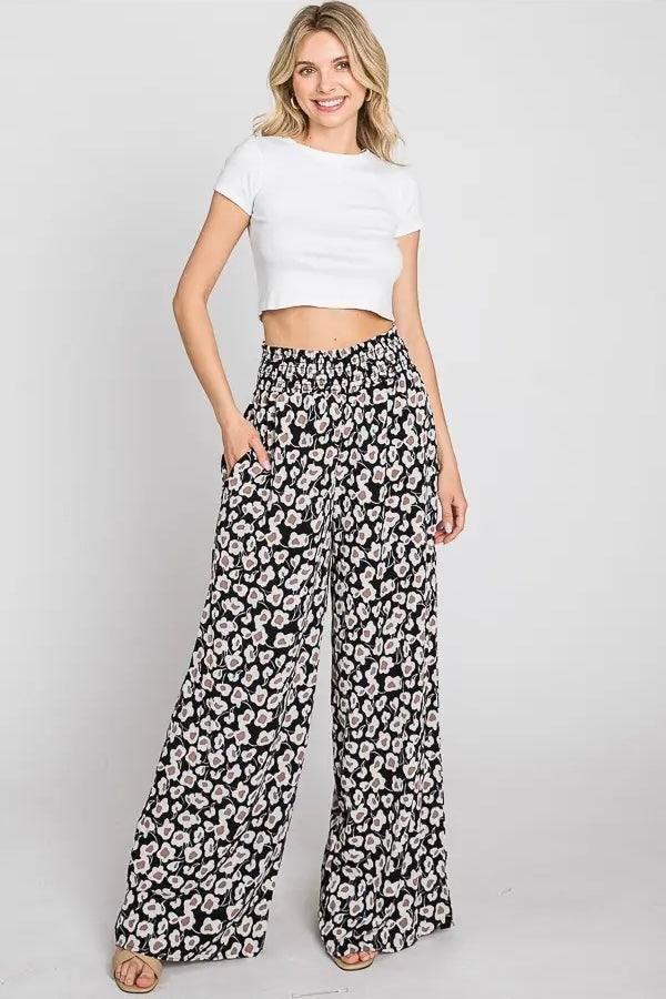 Flowers In Your Hair Retro Vintage Print Smocked Pants shown on model wearing white crop top and sandals against plain background