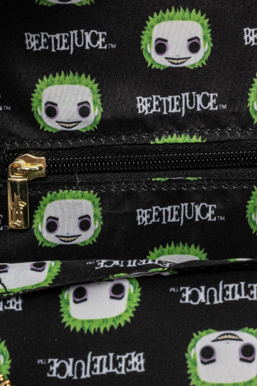 Black fabric featuring green-haired character faces and Beetlejuice text pattern with a gold zipper detail