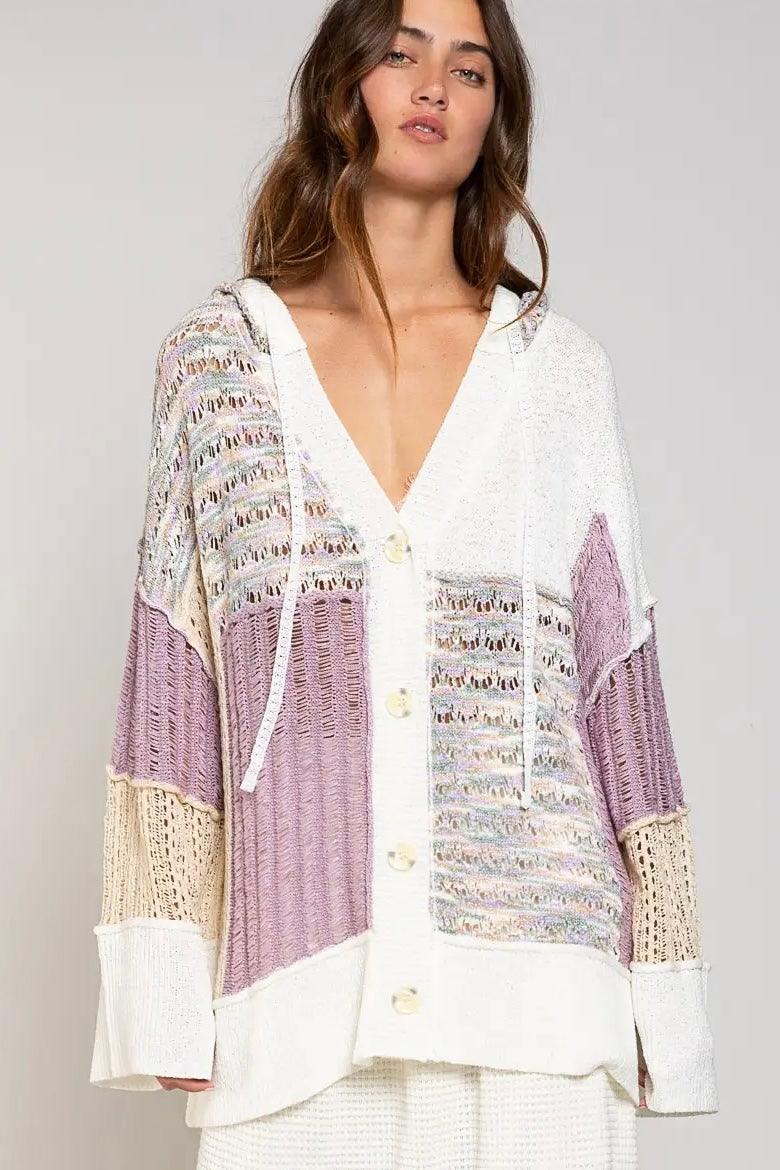 Lightweight knitted cardigan with lavender color blocks, cream accents, large buttons, and an oversized hooded design