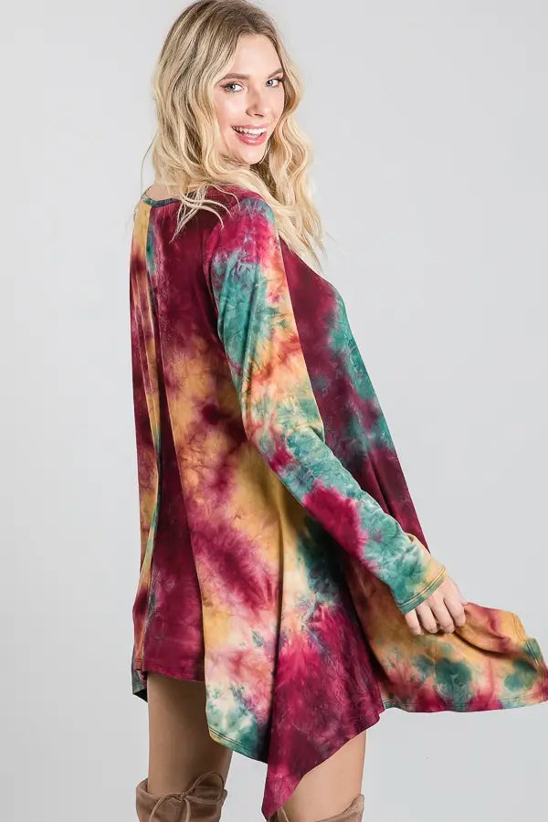 Loose long-sleeve tie-dye dress in ruby, green, and mustard tones with a relaxed, flowing fit and asymmetrical hemline