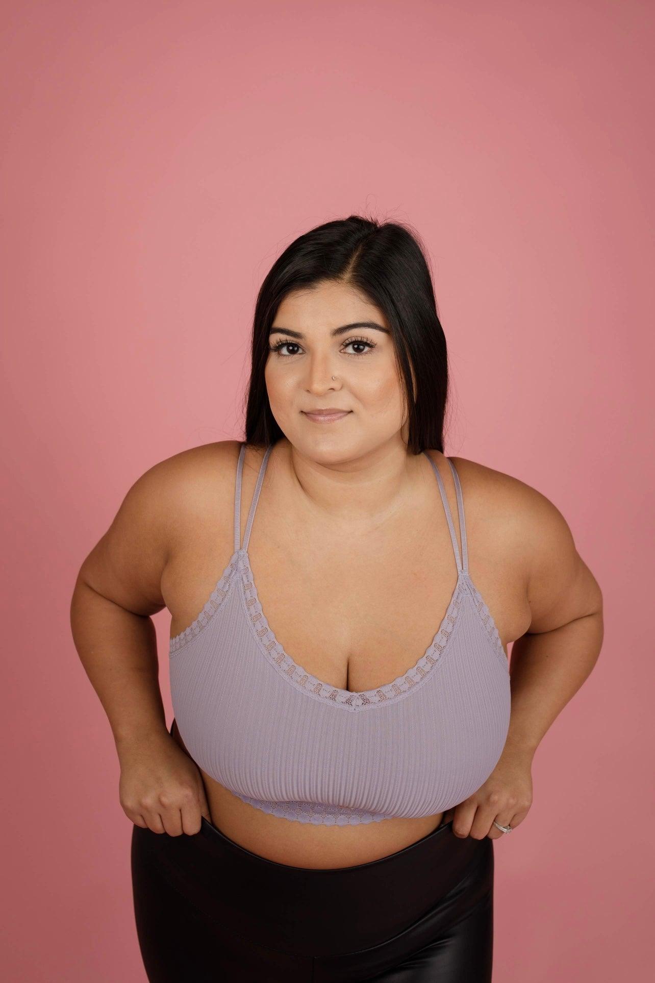 Curved lilac ribbed lace bralette with double thin straps worn by model against soft pink backdrop