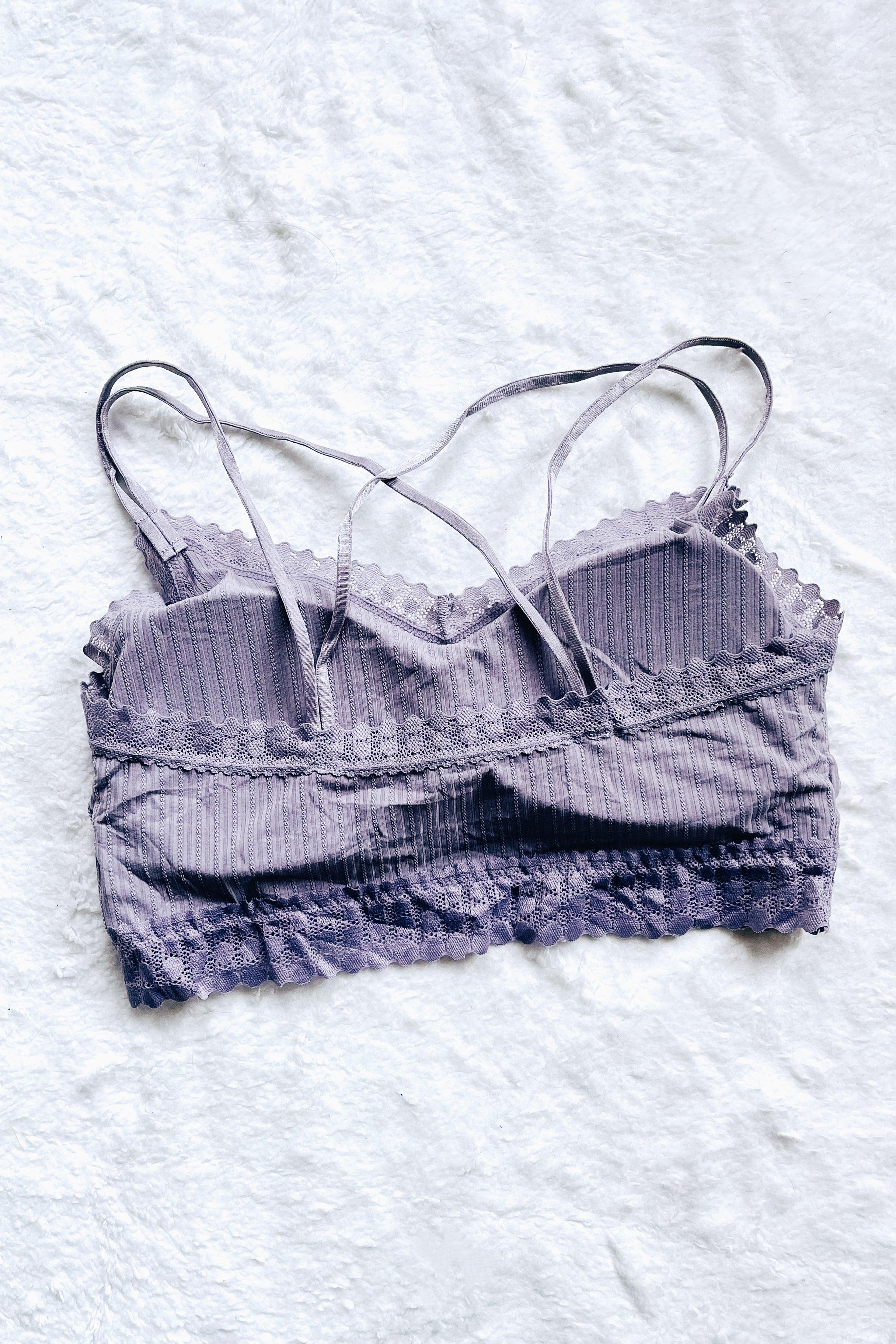 Lilac ribbed lace bralette with delicate scalloped edges and thin adjustable straps on white background