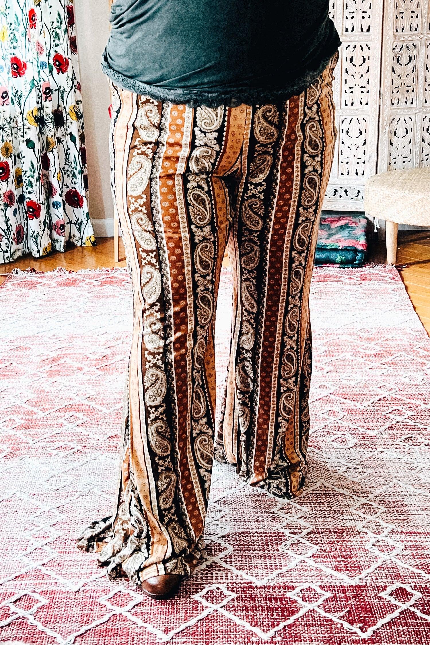 Earth-toned paisley and striped flared pants styled in a free-spirited, eclectic home environment with bold accents