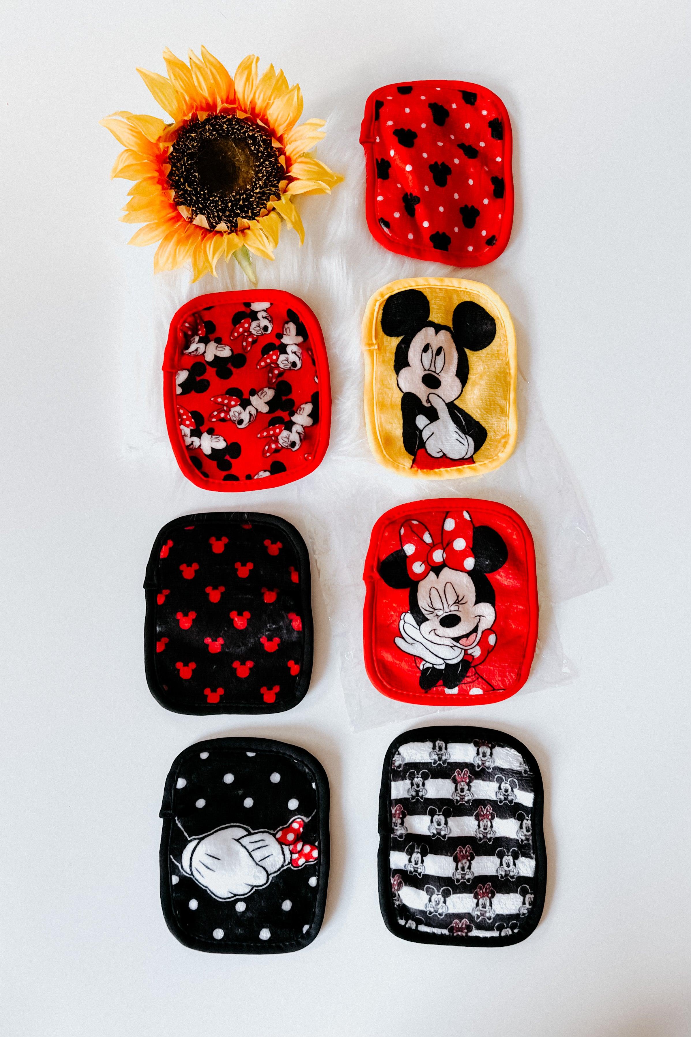 Set of vibrant red, black, and yellow makeup eraser pads featuring Disney Mickey and Minnie Mouse themed patterns with sunflower prop