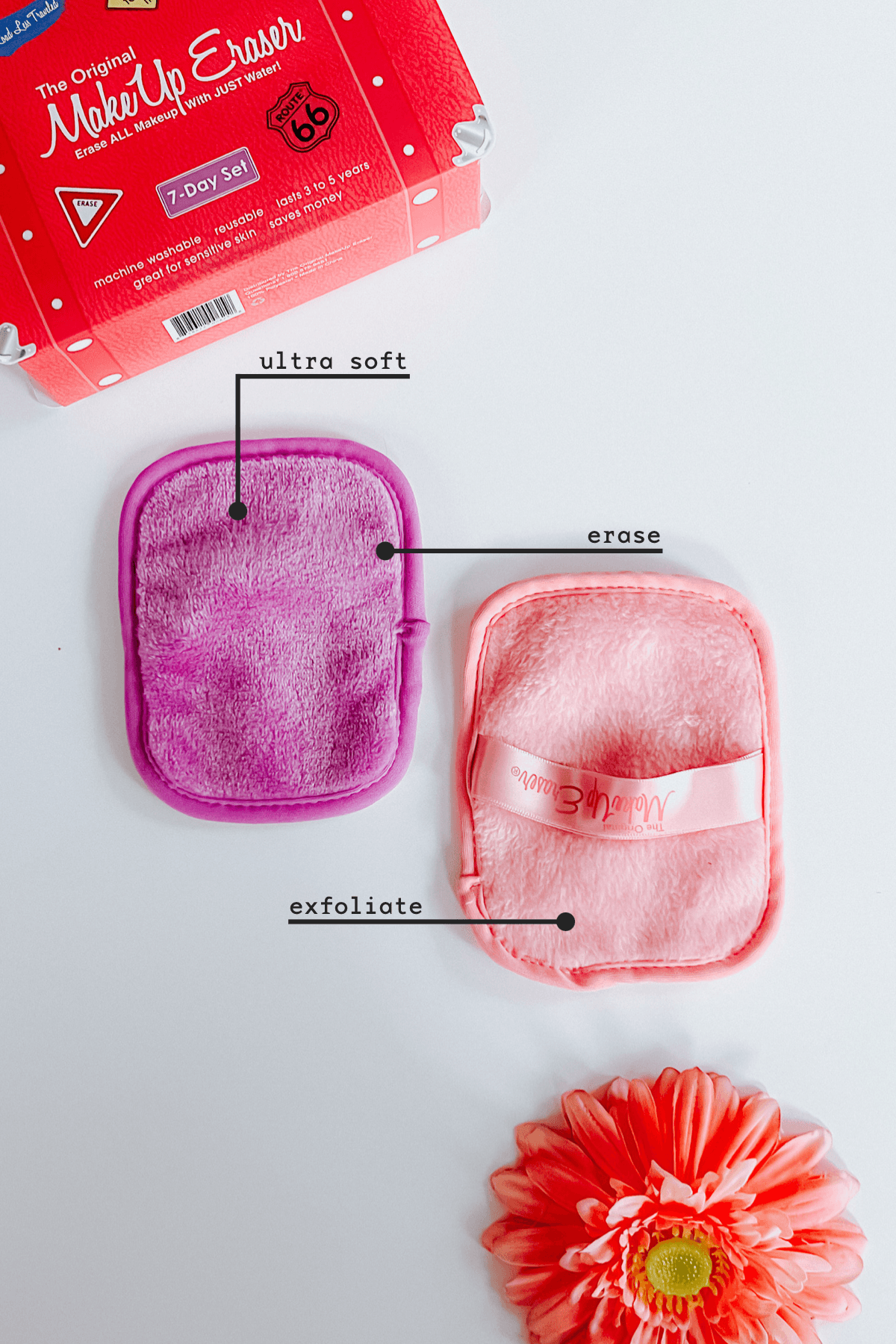 Two plush makeup remover cloths in purple and pink with labeled fabric sides, next to vibrant flower and red packaging
