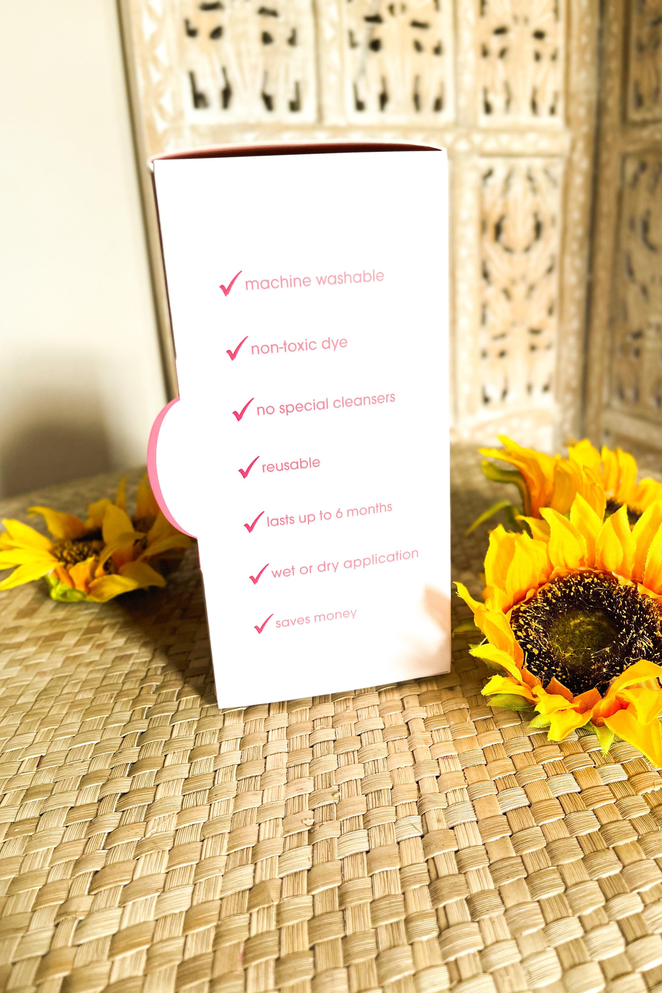 White product box highlighting eco-friendly features beside bright sunflowers on woven surface in natural light