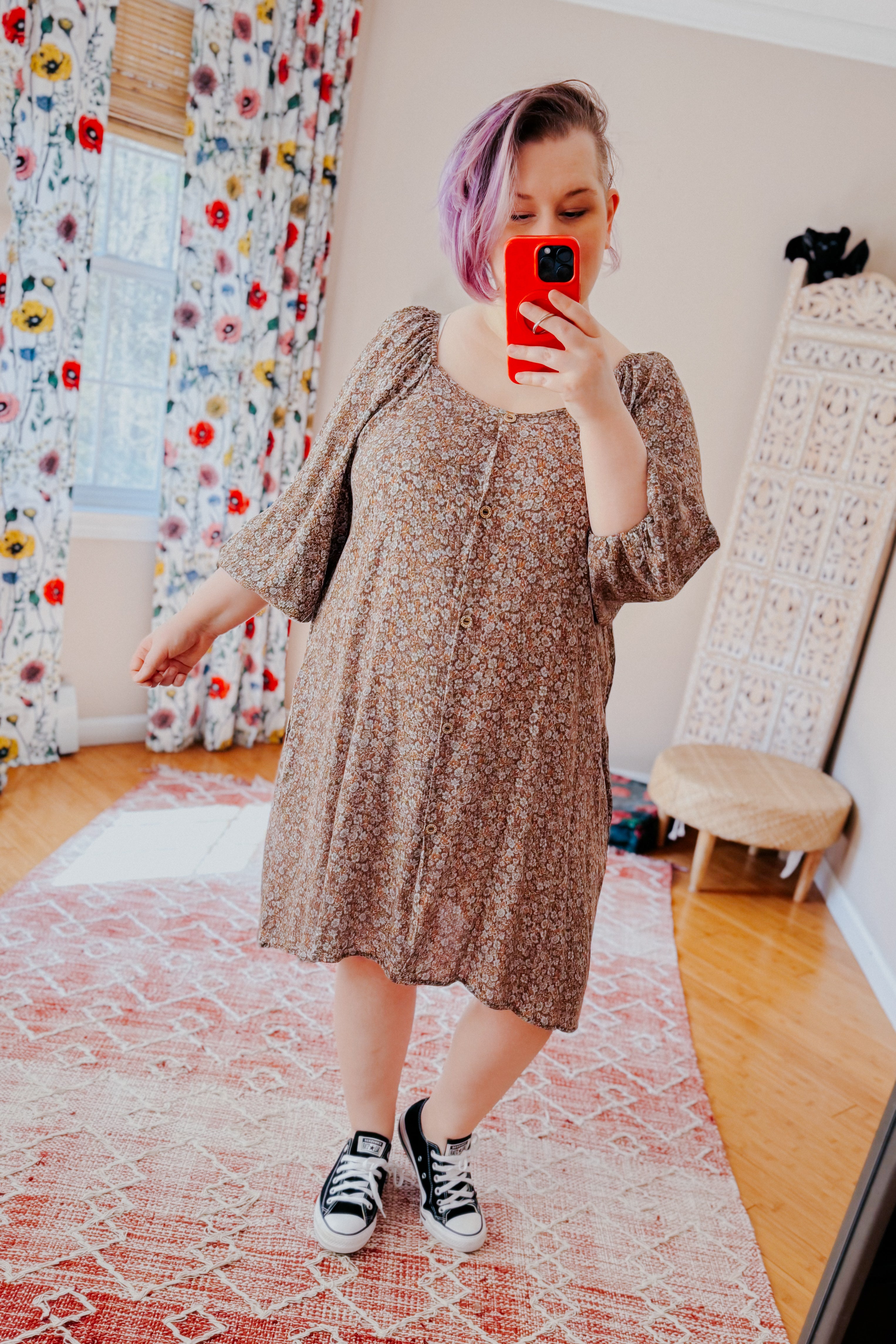 Person with lavender hair taking full-body mirror selfie wearing Autumn Feels Floral Dress and black sneakers in bright room
