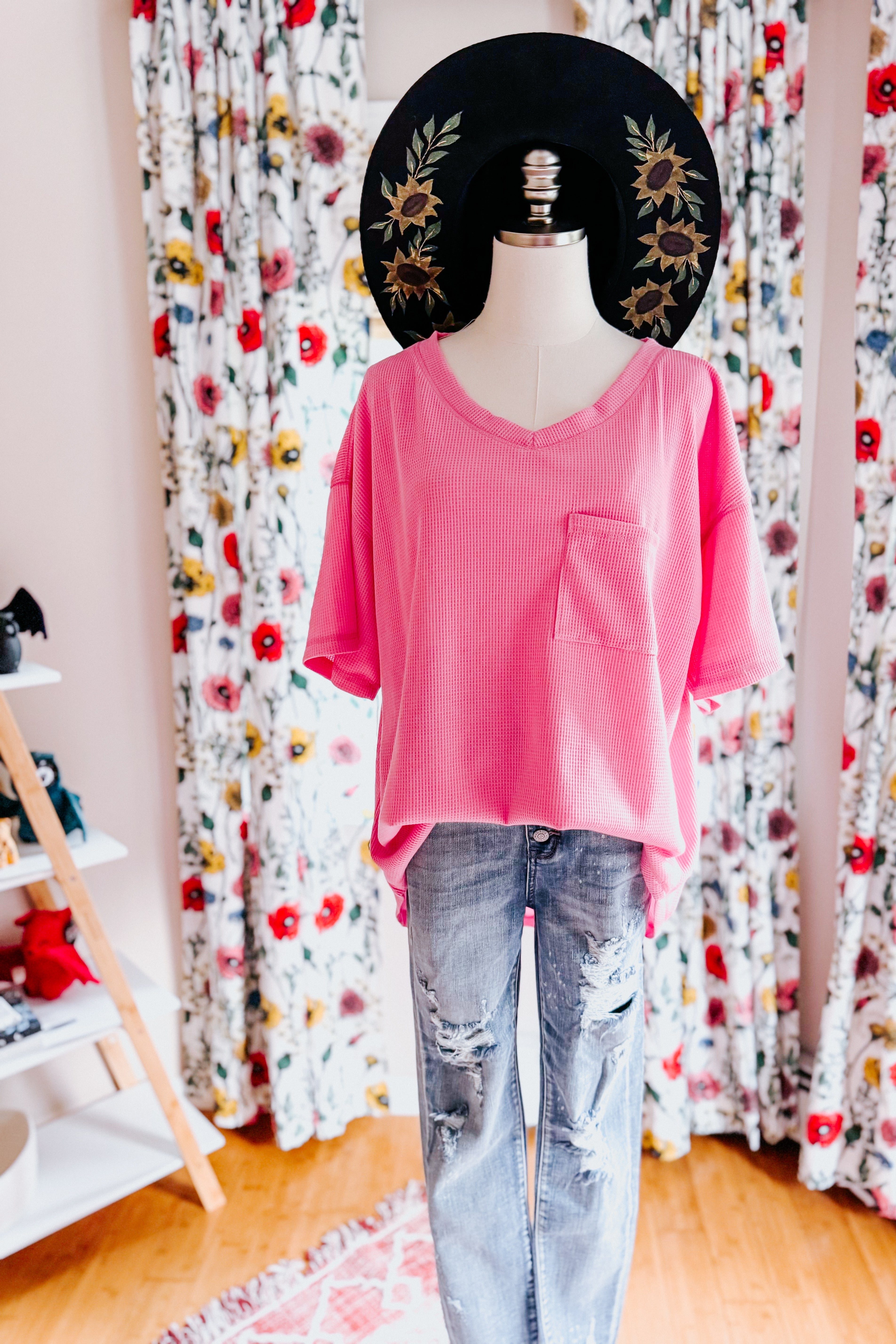 Pink Back Together V-Neck Top with front pocket styled on mannequin against floral curtain backdrop, gallery image 0