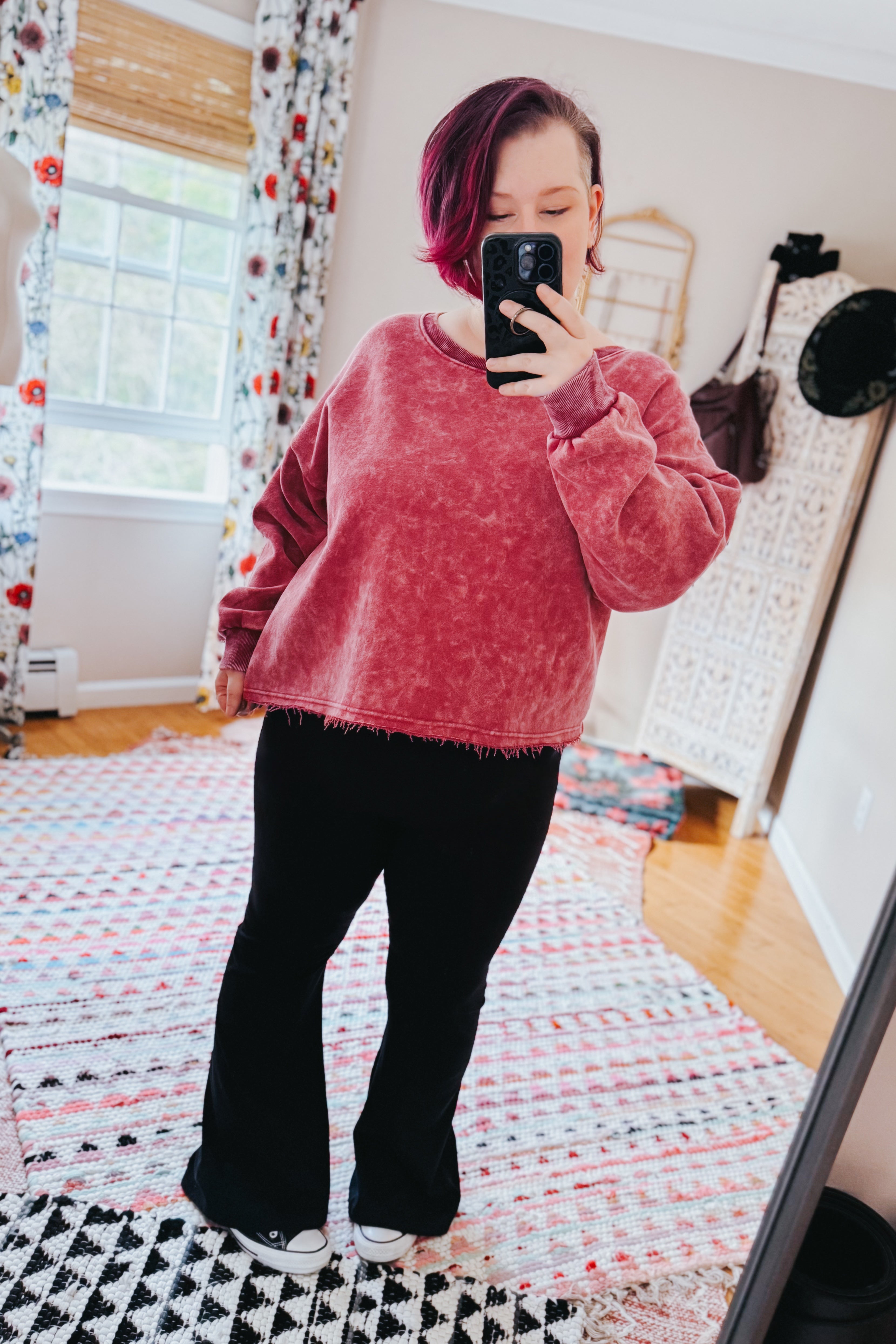 Person with short magenta hair wearing Bad Company Acid Wash Cropped Pullover in berry, standing indoors, full body mirror selfie