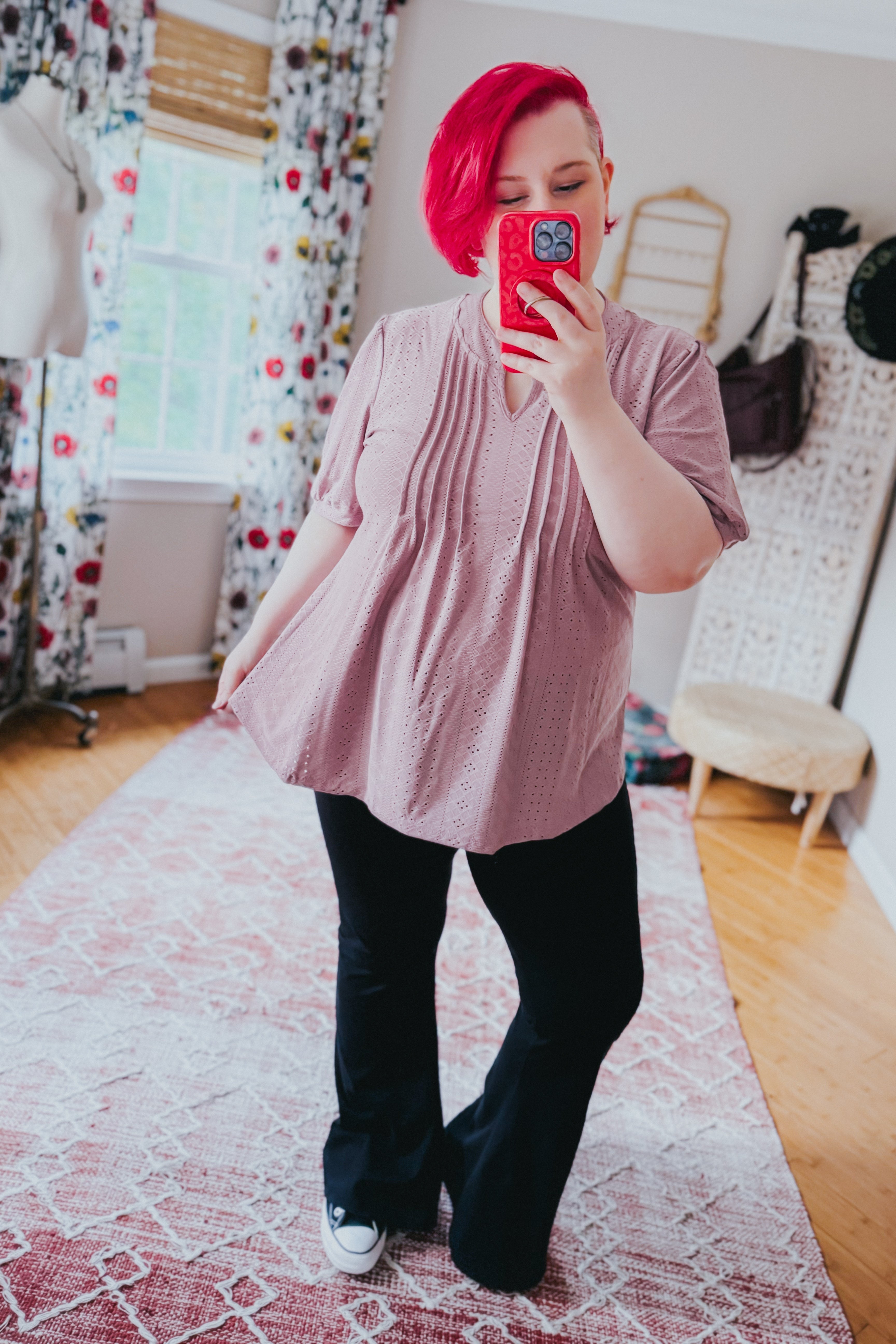 Light mauve pleated front blouse with eyelet design worn with black pants and white sneakers in cozy room mirror selfie