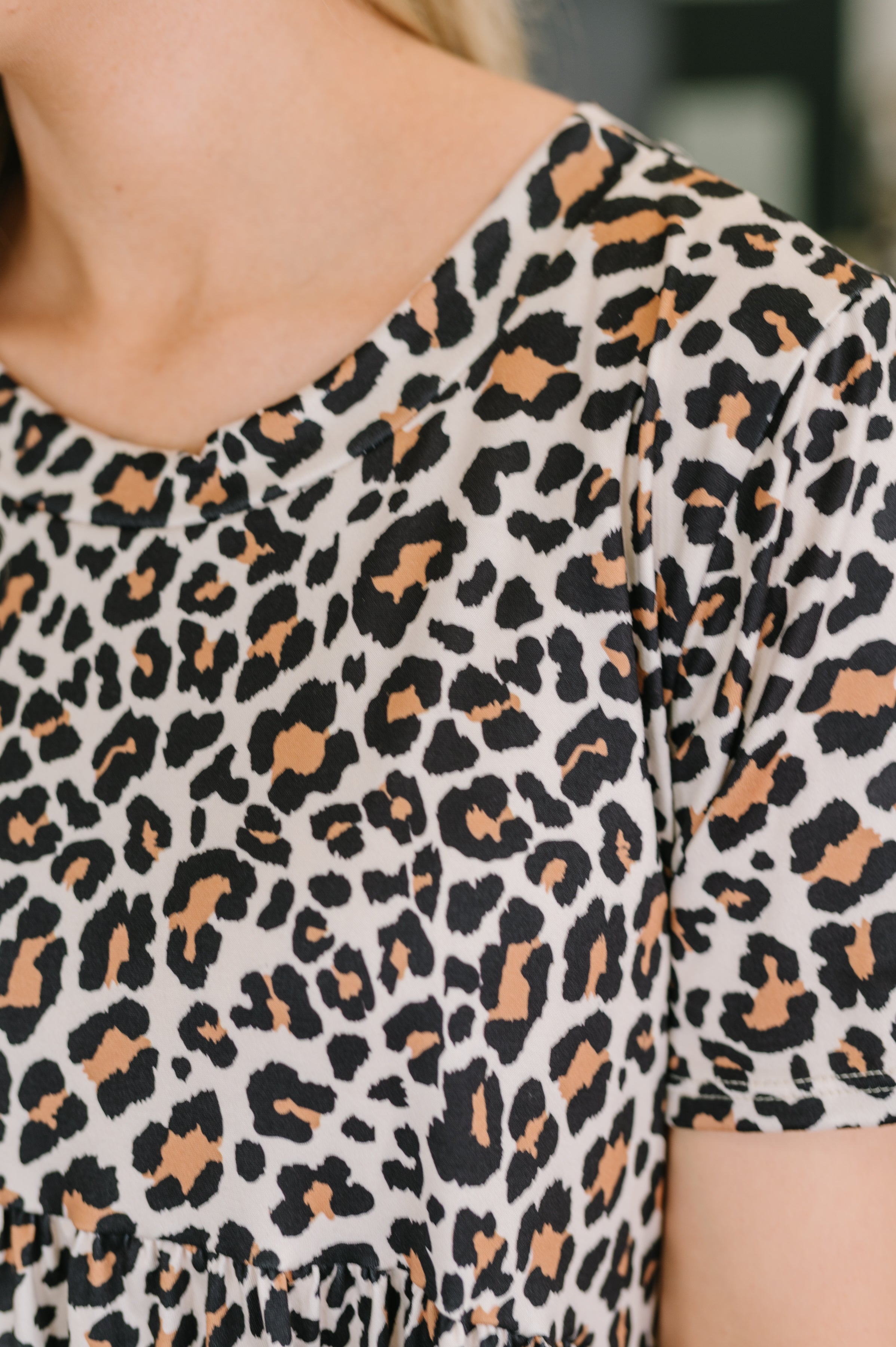 Close-up of cream smock dress with bold leopard print pattern and soft jersey knit fabric in eclectic, free-spirited style
