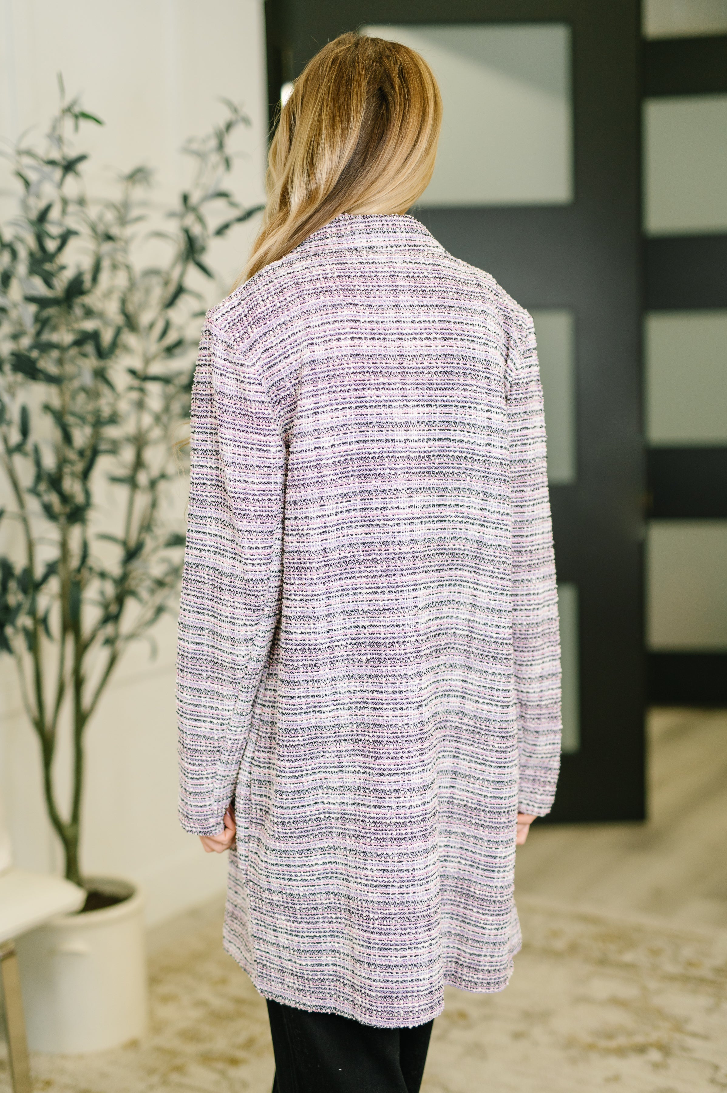 Back view of woman wearing Lavender Ivory Brixton Tweed midi blazer with long sleeves in indoor setting