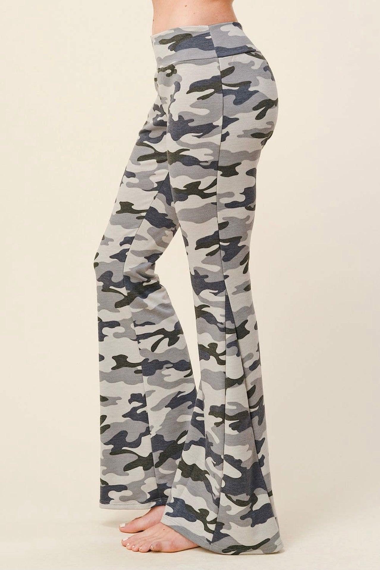 Side view of high-waisted flare pants featuring light gray and navy blue camouflage print worn barefoot