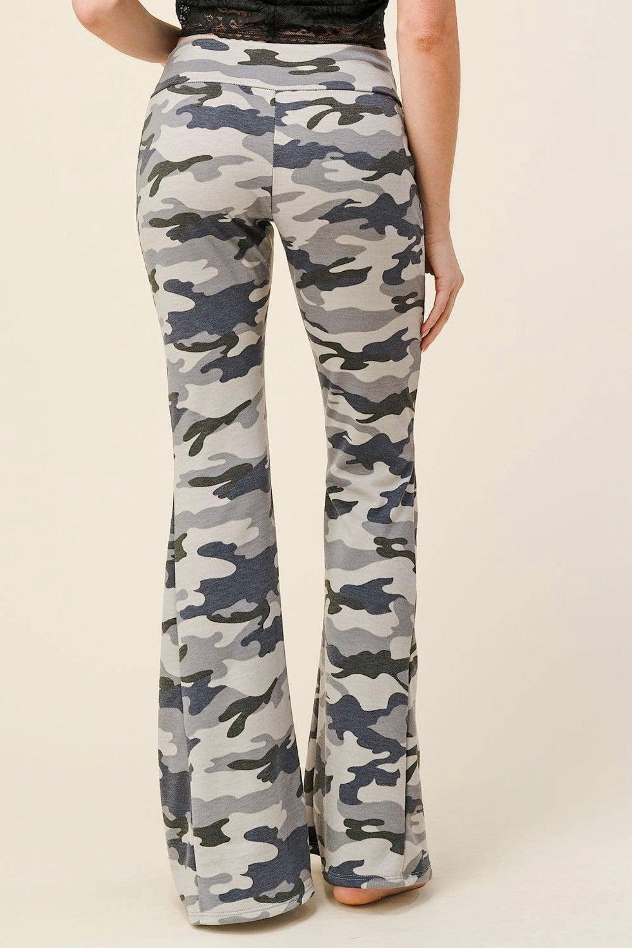Back view of high-waisted flare pants in muted gray and navy blue camouflage pattern worn by a barefoot model