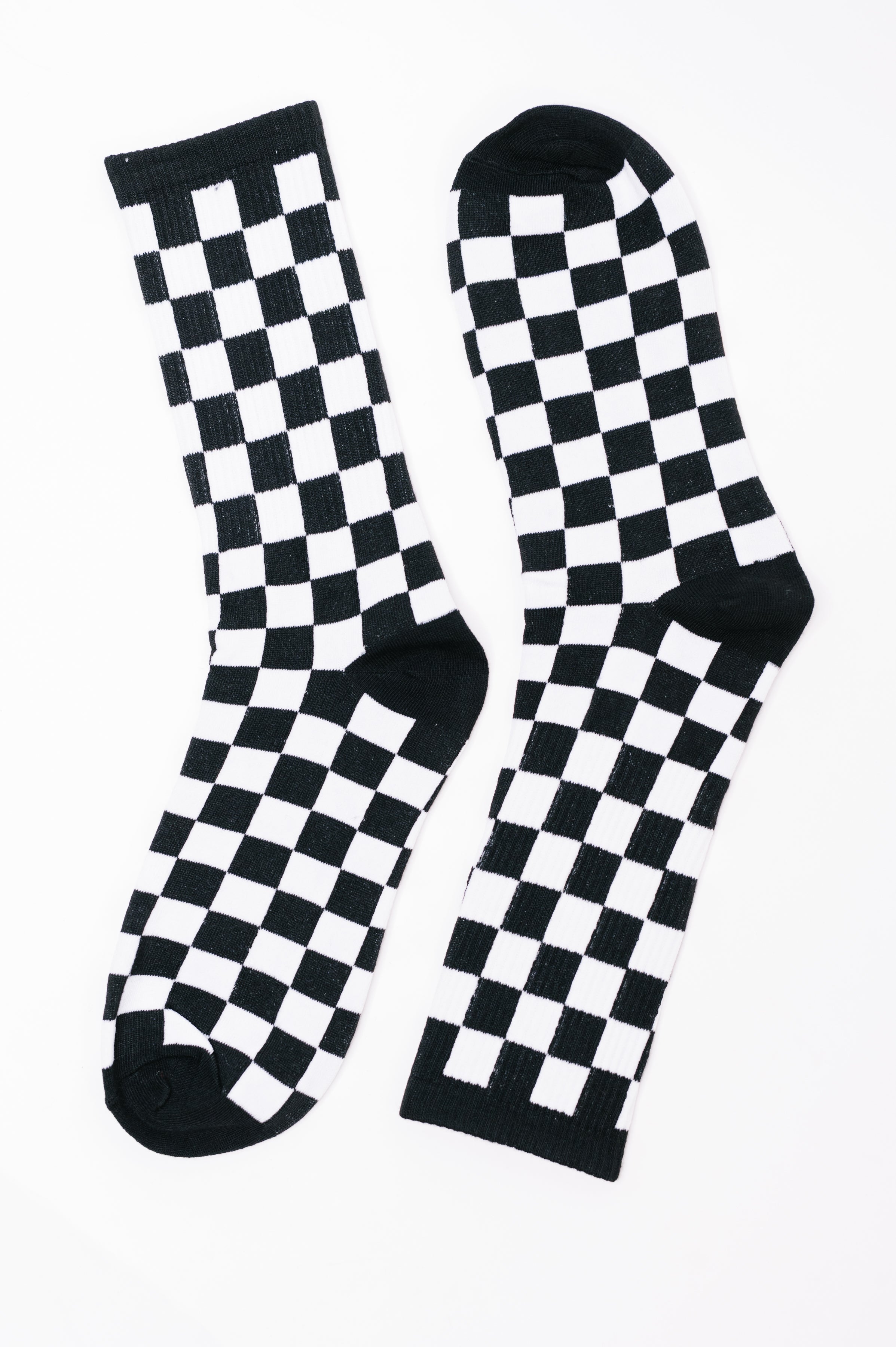 Pair of black and white checkered quarter-length socks laid flat on white background