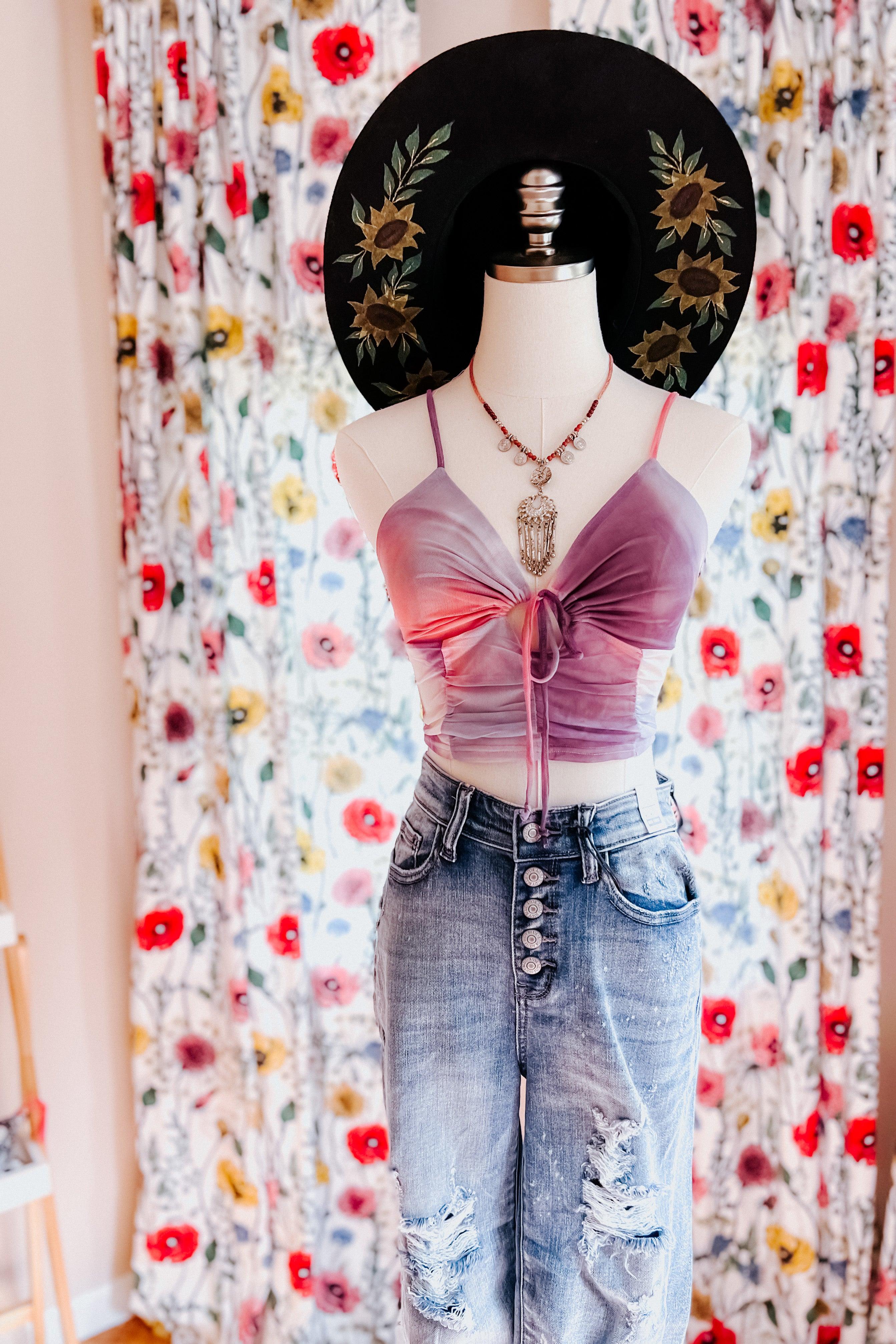 Purple and pink tie dye mesh brami top with front tie detail on mannequin styled with distressed jeans and layered necklace
