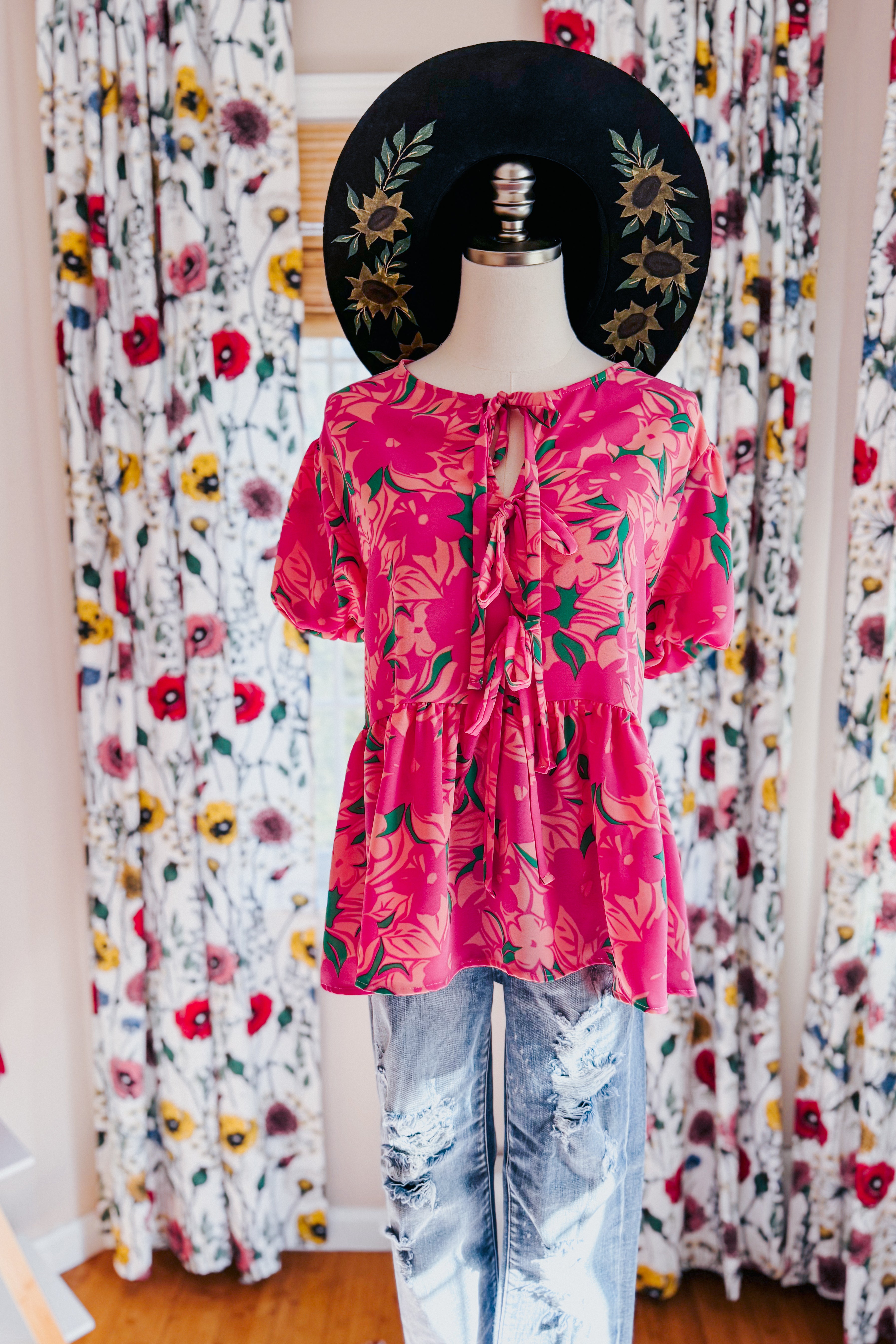 Floral Fling Puff Sleeve Blouse in bright pink with floral print and front tie detail styled with distressed jeans